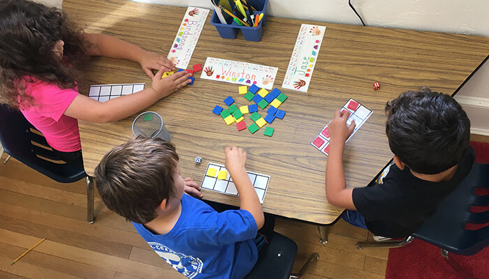 Kindergarten students work with math manipulatives.