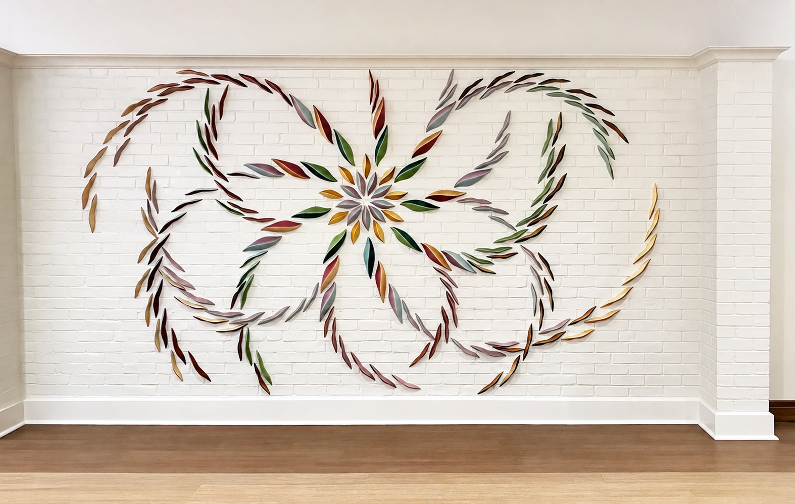 Ceramic Leaf Installation on White Brick.png