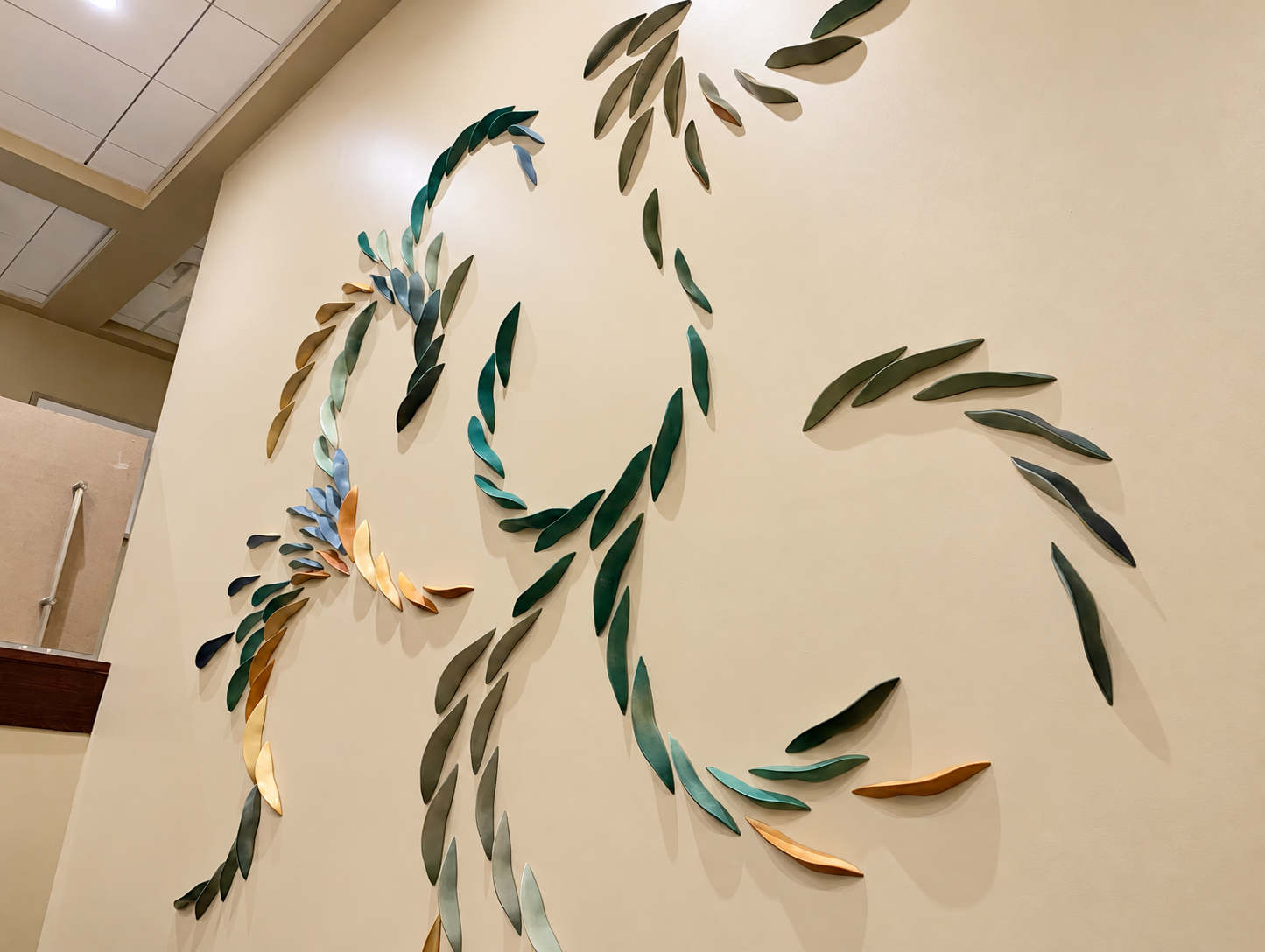 Brightened ceramic leaf wall installation.png