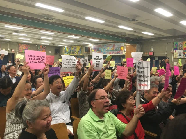 Chinatown residents jeered at city officials.