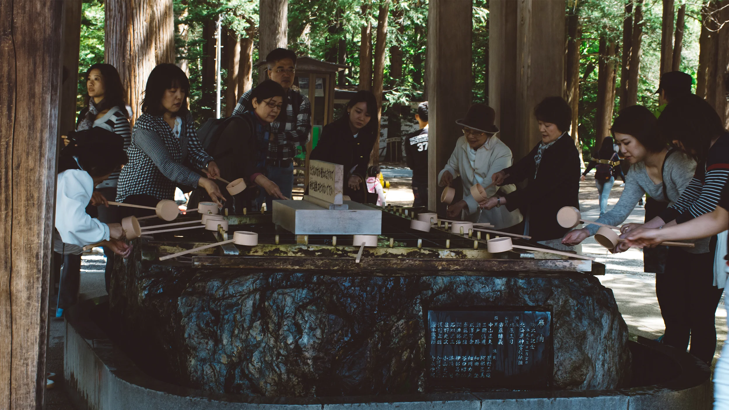 Hokkaido Shrine. Sapporo. Visitors performing a Shinto purification. 