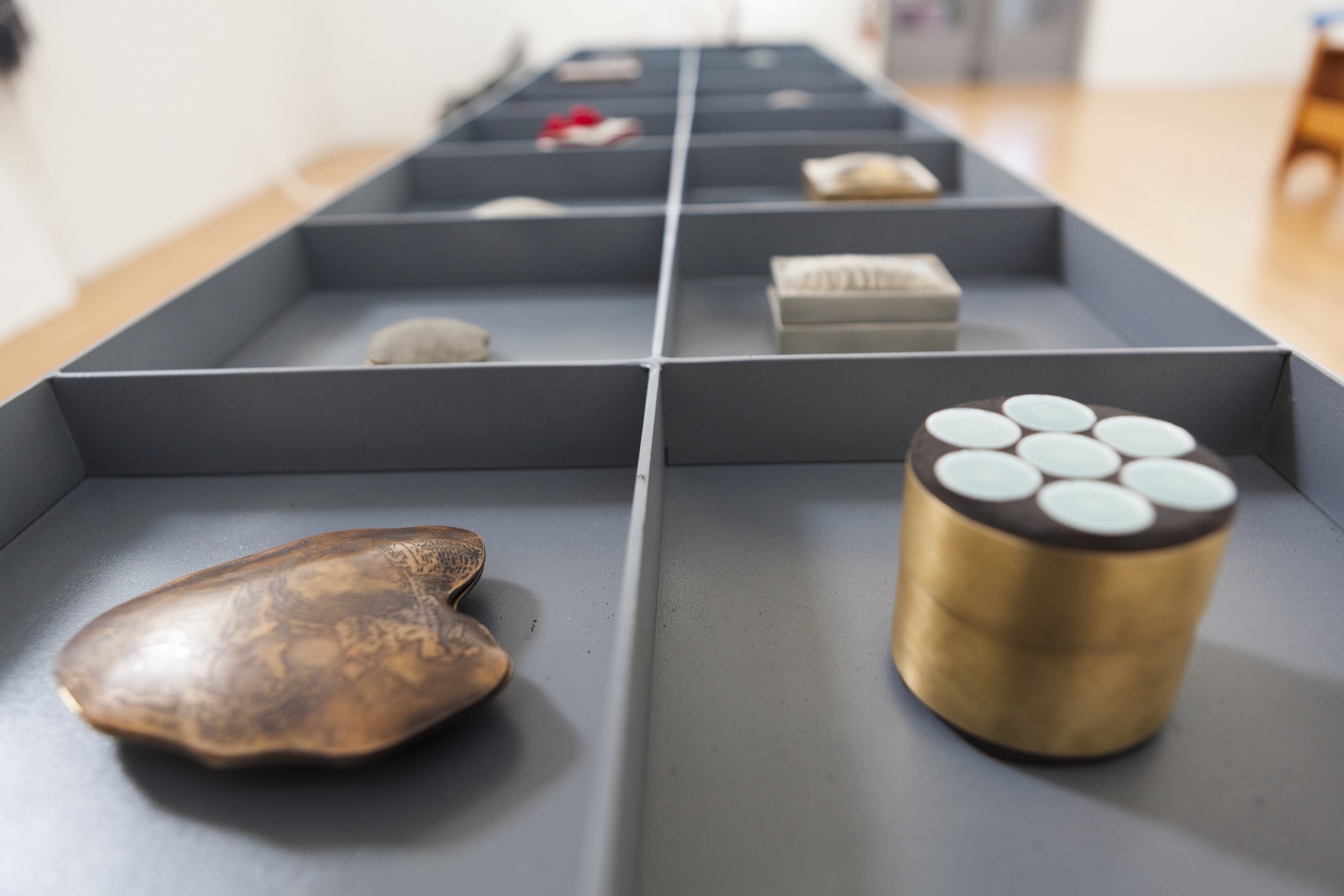 People Don't See the Weight, 2017 (Installed) As a rape survivor, I have struggled with depression and PTSD. For my thesis project I conducted interviews with fifteen rape and sexual abuse survivors. I created a metal object for each contributor, which convey the secretiveness of sexual violence. The outer surface of each piece appears ordinary, while the inside, reveals distress. This work is displayed on a table to encourage viewers to interact with the pieces. Behind the table, letterpressed quotes from each participant hang on the wall. My responsibility as an artist is to create an outlet for survivors to be heard.