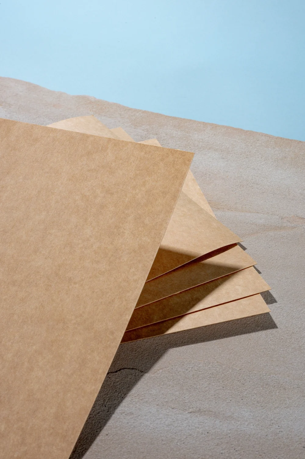 Kraft sheets fanned under blue sky