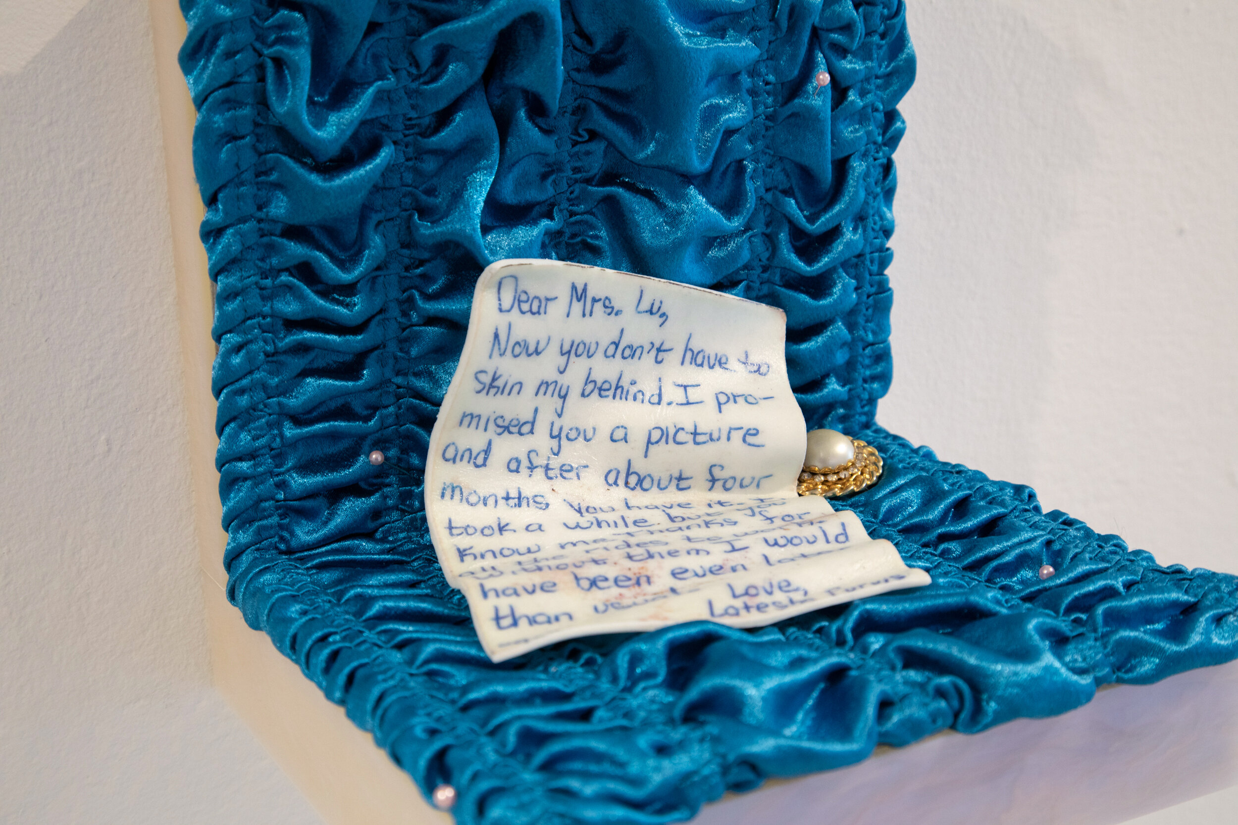  Karinne Smith  Pinkie , 2020 (letter detail) Blue Satin, Vanilla Fondant, Earring, Pink Sewing Pins, Pearlescent Acrylic, Wood 8 x 7 x 7 inches (20 x 18 x 18 cm) 