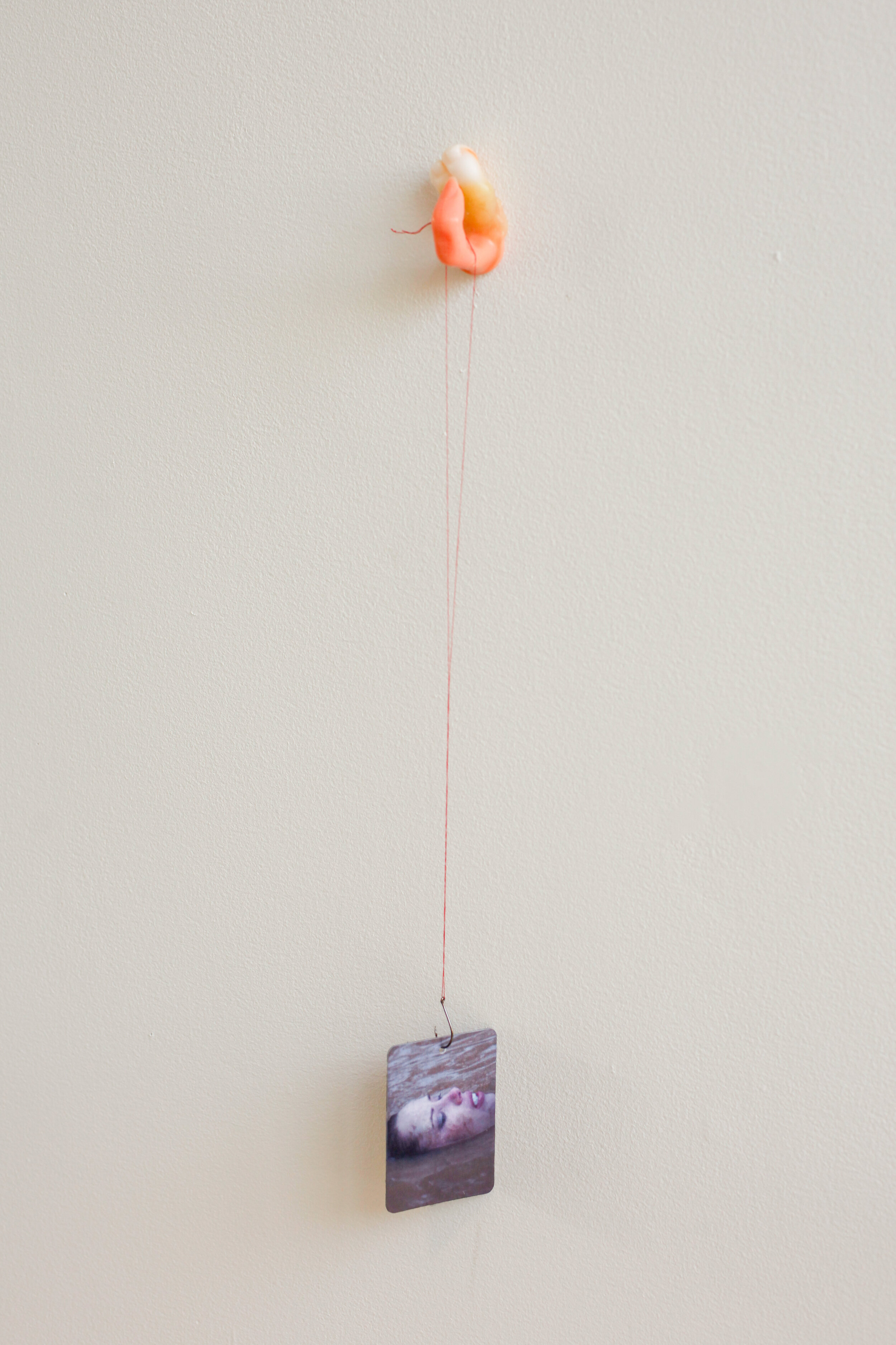  Lauren Lee  Untitled , 2019  Thirteen Customized car fresheners, plastic manicure practice finger, thread,  fish hook, paraffin wax, blend of essential Oils: "Puppy Paws," "Basement" and "Dusty Carpet" 18 x 3.3 ’x 3 inches (46 x 8 x 8 cm) approximat