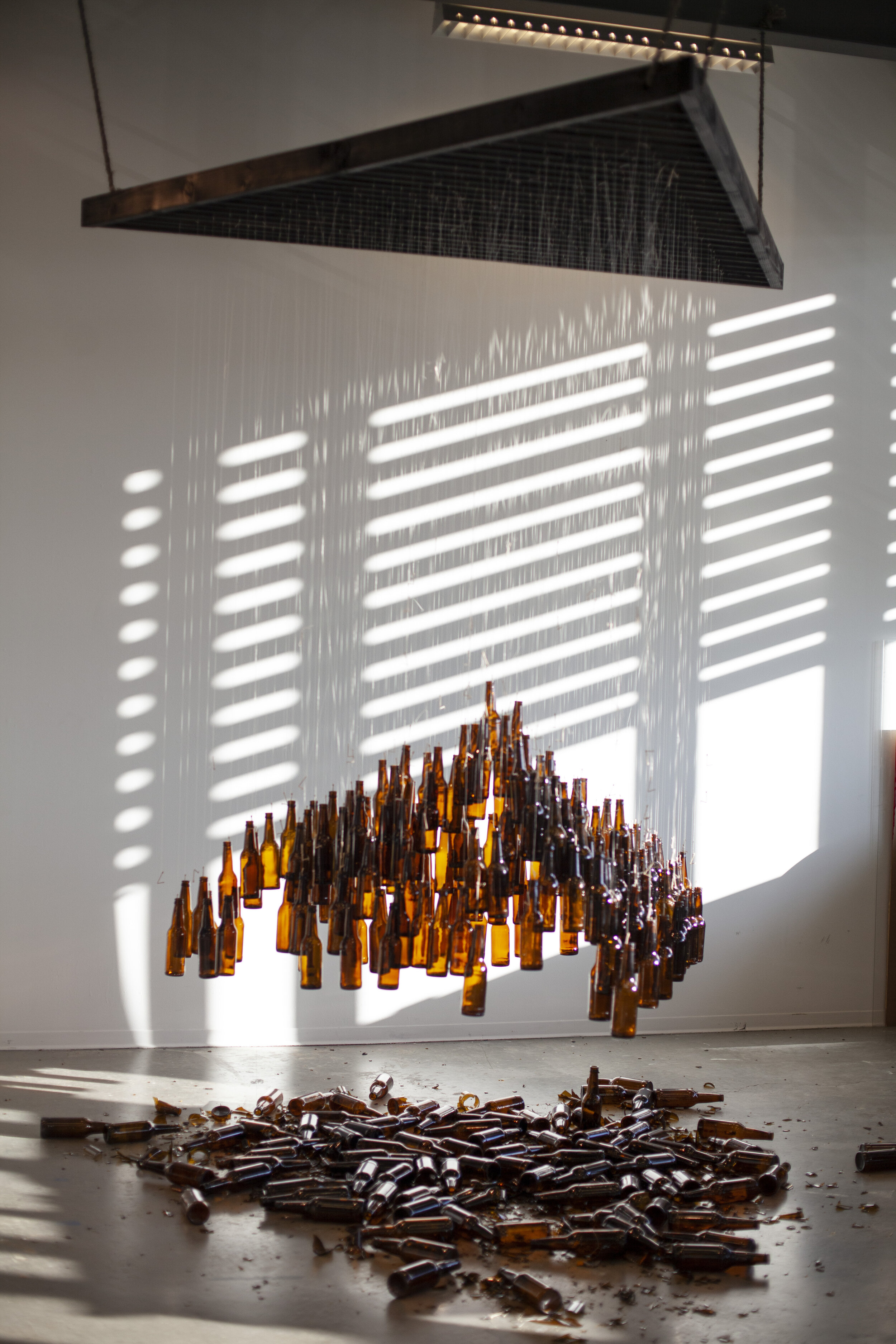  Anna Miller  HOURGLASS , 2019 Toothpicks, beer bottles, thread, wood, rope 180 x 108 inches (457 x 274 cm) 
