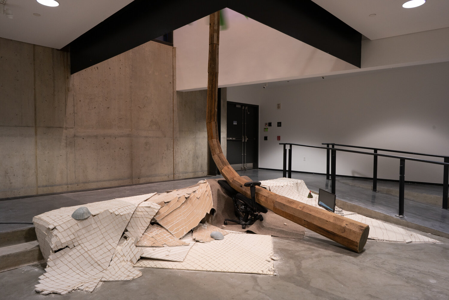  Alex Zak  Swamped , 2019 Sheet rock, plaster wrap, carpet, wood, steel, aluminum, paint, cement, sand, oven-bake clay,   office chair, modified ceiling fan, Monitor, Keyboard, aquarium volcano, red sharpie 192 x 204 x 196 inches (488 x 305 x 498 cm)
