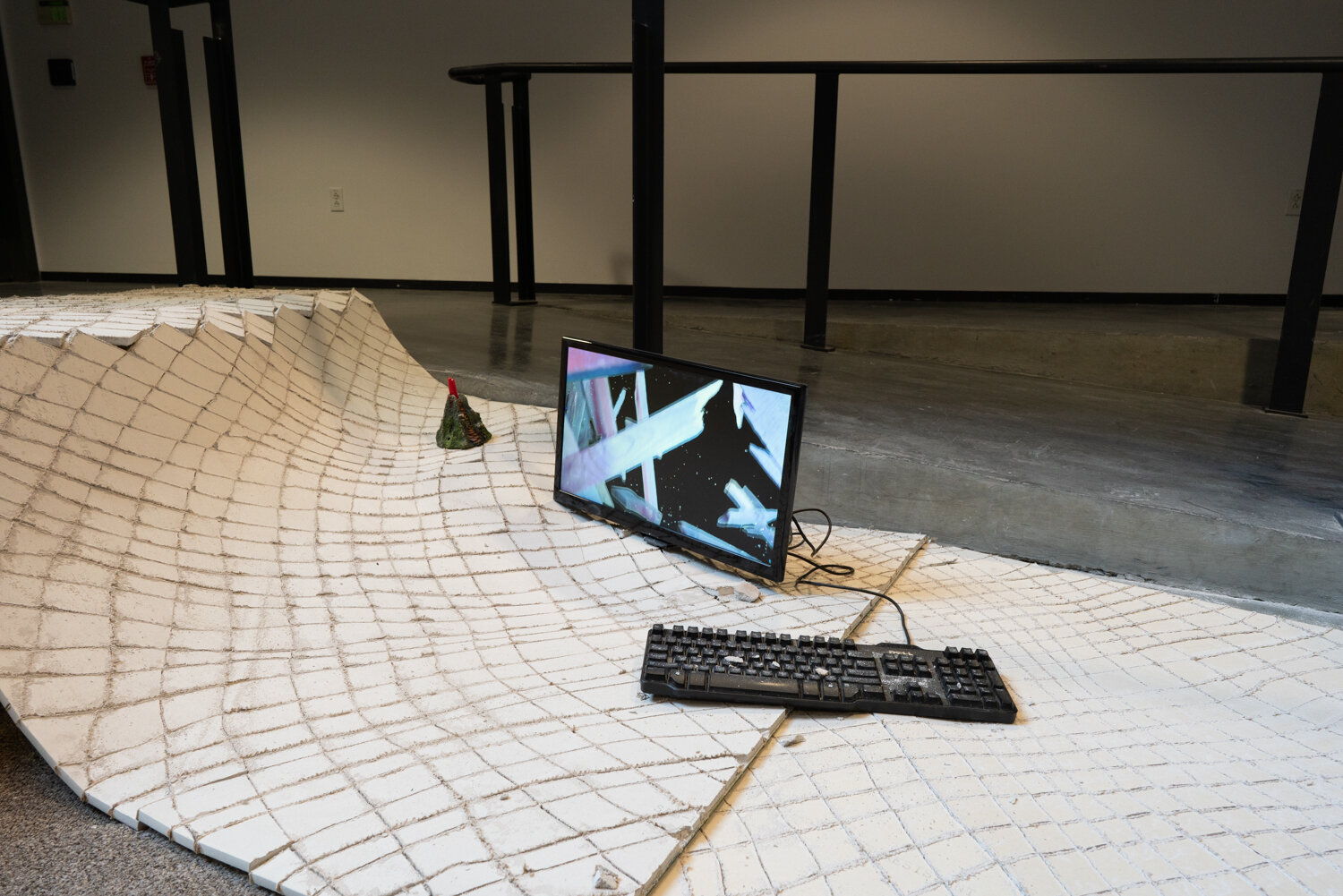  Alex Zak  Swamped , 2019 (detail) Sheet rock, plaster wrap, carpet, wood, steel, aluminum, paint, cement, sand, oven-bake clay,   office chair, modified ceiling fan, Monitor, Keyboard, aquarium volcano, red sharpie 192 x 204 x 196 inches (488 x 305 