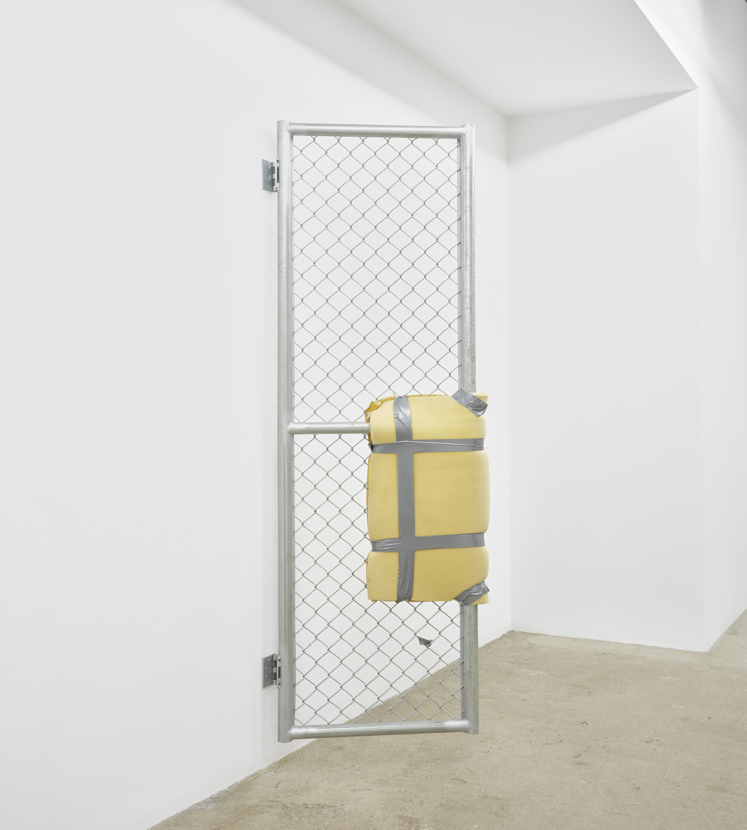  Bat-Ami Rivlin  Untitled (metal gate, yellow foam, duct tape) , 2019   chain link fencing, metal frame, hinges,   polyisocyanurate foam, duct tape, hardware 84&nbsp;1⁄2&nbsp;x 5 x 24 inches (215 x 8 x 61 cm) BR3 