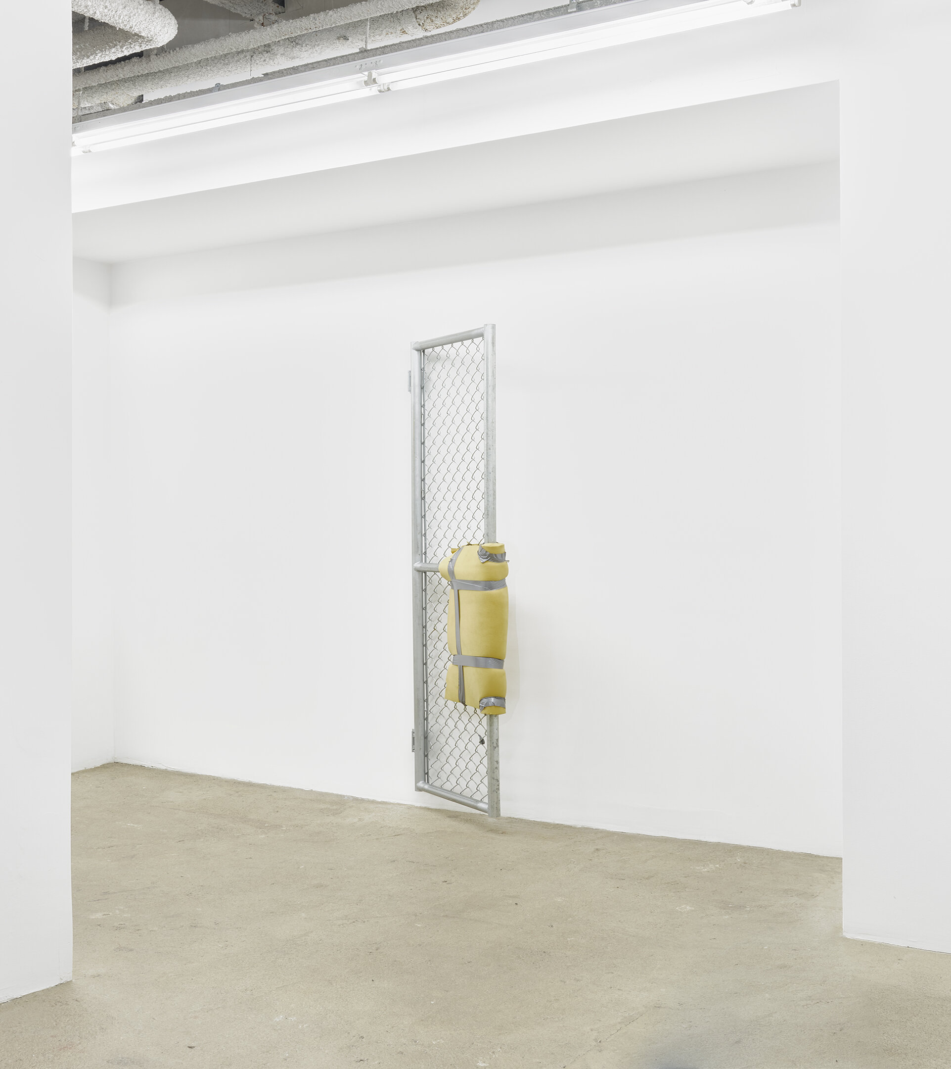  Bat-Ami Rivlin  Untitled (metal gate, yellow foam, duct tape) , 2019   chain link fencing, metal frame, hinges,   polyisocyanurate foam, duct tape, hardware 84&nbsp;1⁄2&nbsp;x 5 x 24 inches (215 x 8 x 61 cm) BR3 