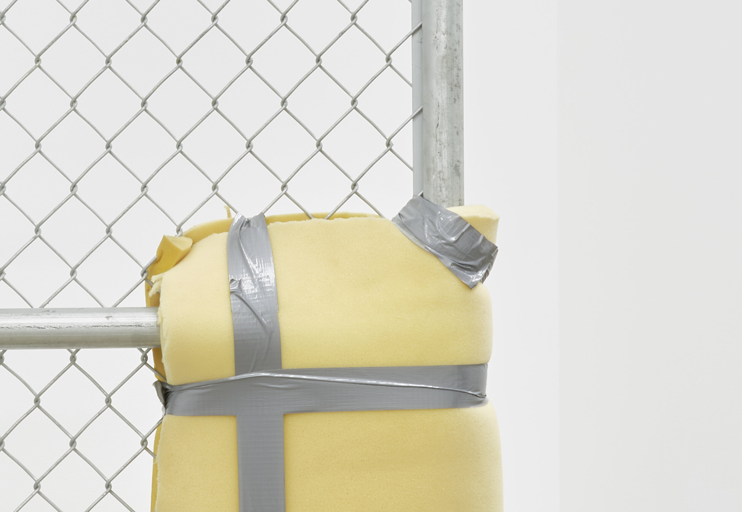  Bat-Ami Rivlin  Untitled (metal gate, yellow foam, duct tape) , 2019 (detail) chain link fencing, metal frame, hinges, polyisocyanurate foam, duct tape, hardware 84&nbsp;1⁄2&nbsp;x 5 x 24 inches (215 x 8 x 61 cm) BR3 