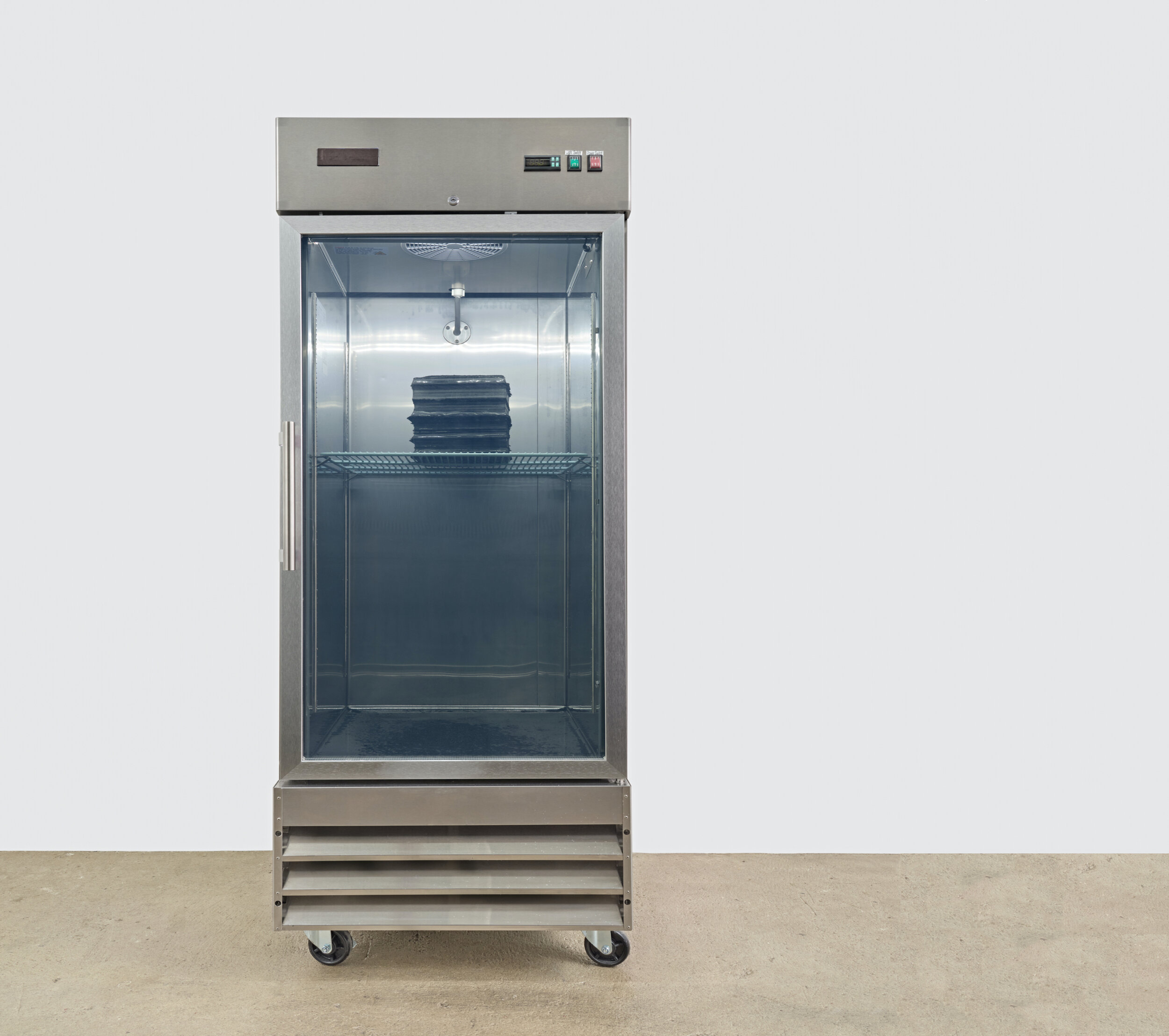  Sae Jun Kim  Solicitude in stratum’s loss , 2021 commercial freezer, water, carbon sediment  82 x 29 x 34 inches (208 x 74 x 86 cm) 
