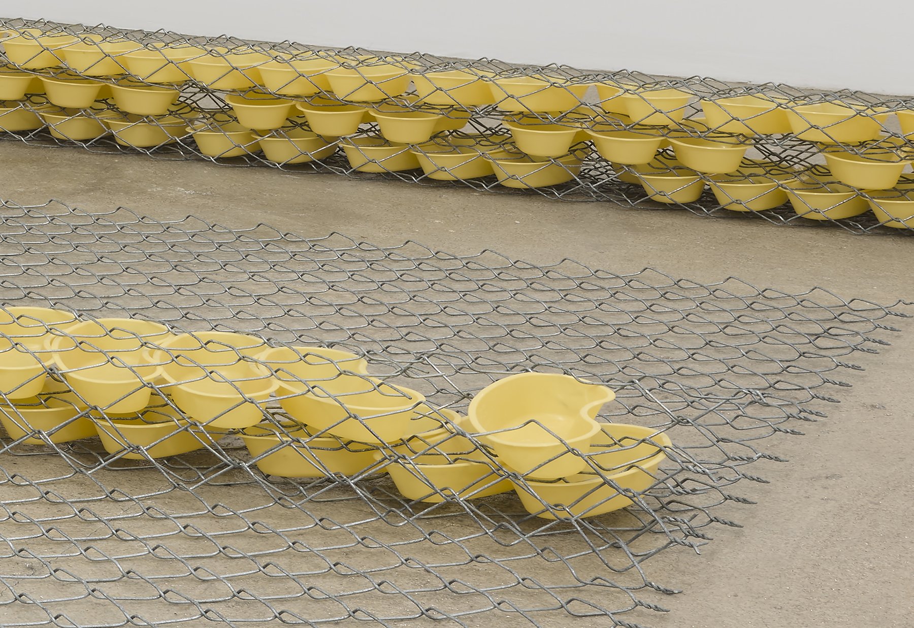  Bat-Ami Rivlin  Untitled (fence, bedpans) , 2021 (detail) chain link fencing, yellow kidney basins  8 x 120 x 72 inches (20 x 305 x 183 cm)  (BR21) 