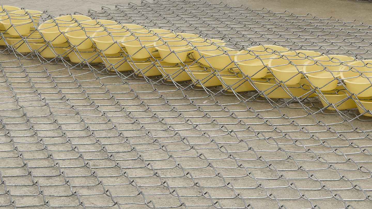  Bat-Ami Rivlin  Untitled (fence, bedpans) , 2021 (detail) chain link fencing, yellow kidney basins  8 x 120 x 72 inches (20 x 305 x 183 cm)  (BR21) 