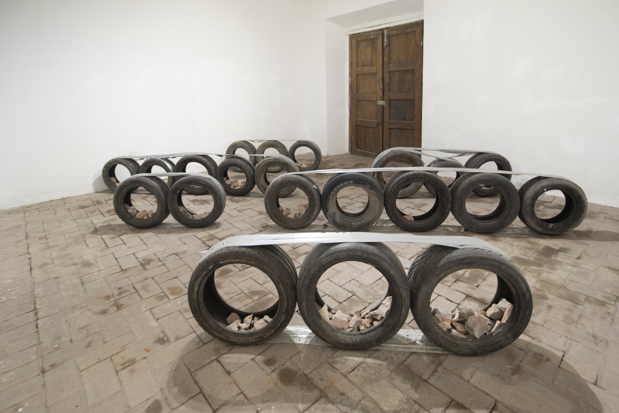  Bat-Ami Rivlin  Untitled (duct tape, duct tape, duct tape, tires) , 2022 tires, duct tape, found bricks dimensions variable to installation BR47 