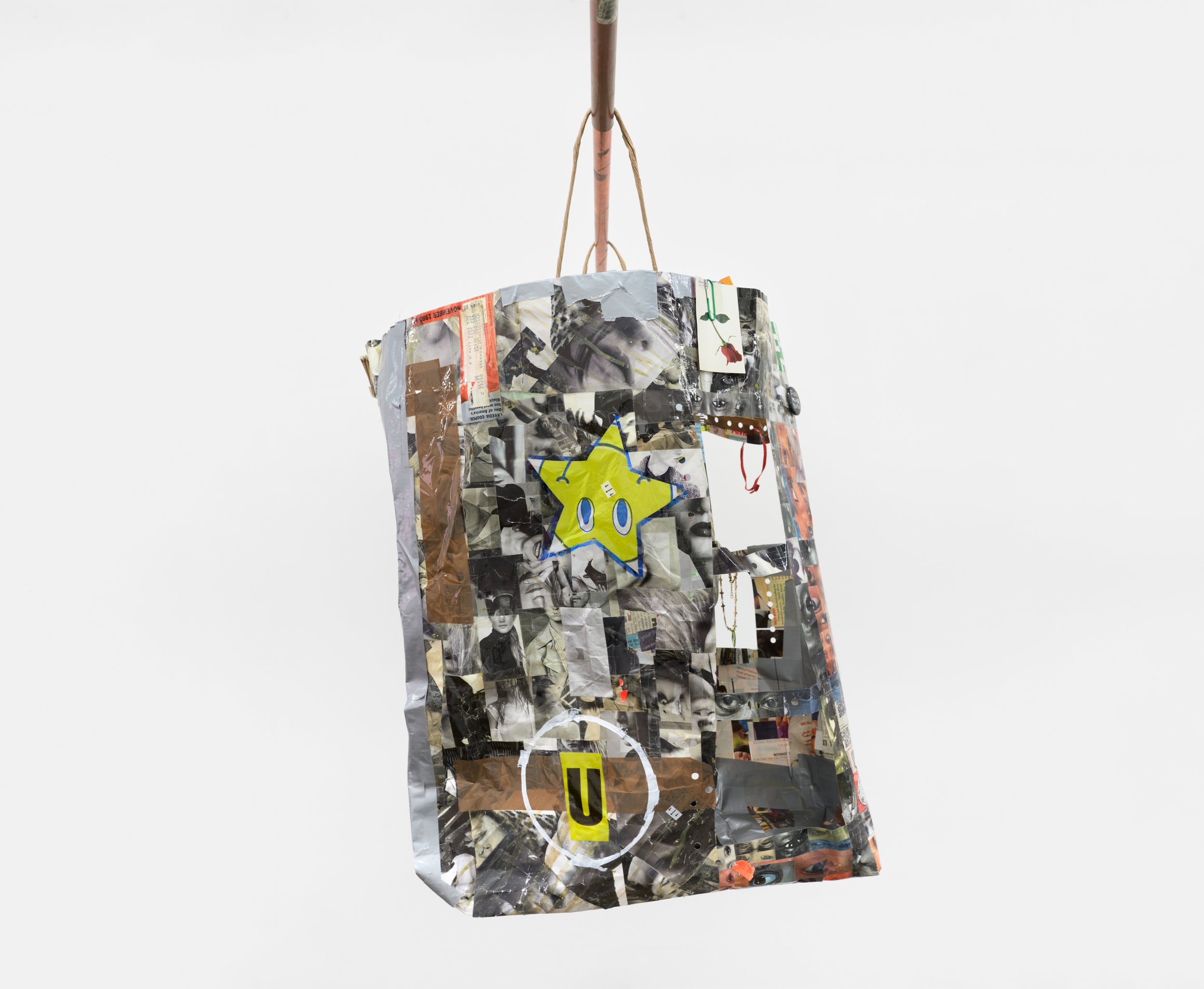  Elzie Williams III  If I Ruled The World (Time Traveler Bag) , 2023 (side 2) magazines, found qr codes, clear tape, found objects, copper  26 x 18 x 6 inches (66 x 46 x 15 cm) EW9 