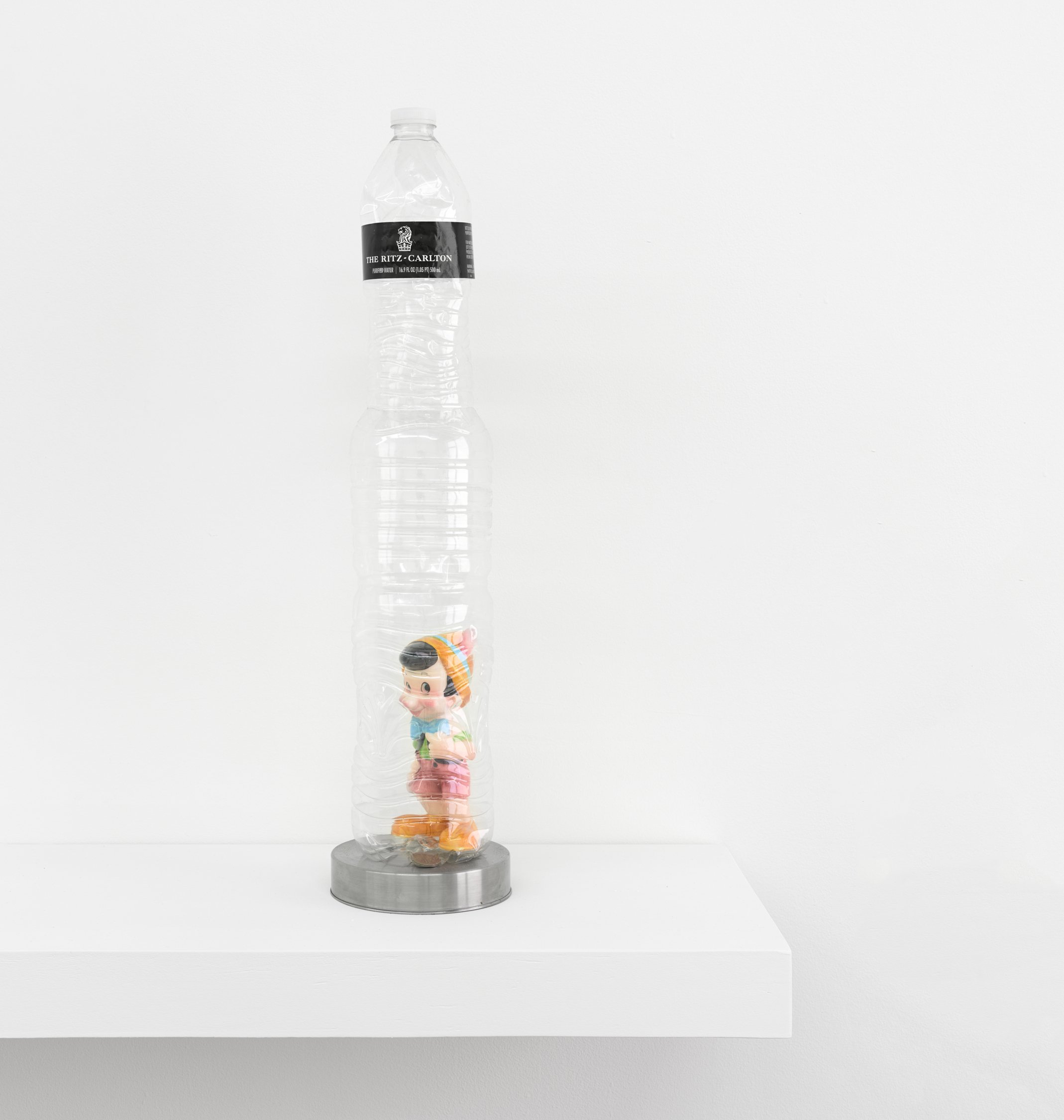  Elzie Williams III  Monstro , 2023 water bottles, figurine, ten cents, metal, readymade shelf  19 x 5 x 5 inches (48 x 13 x 13 cm) EW14 