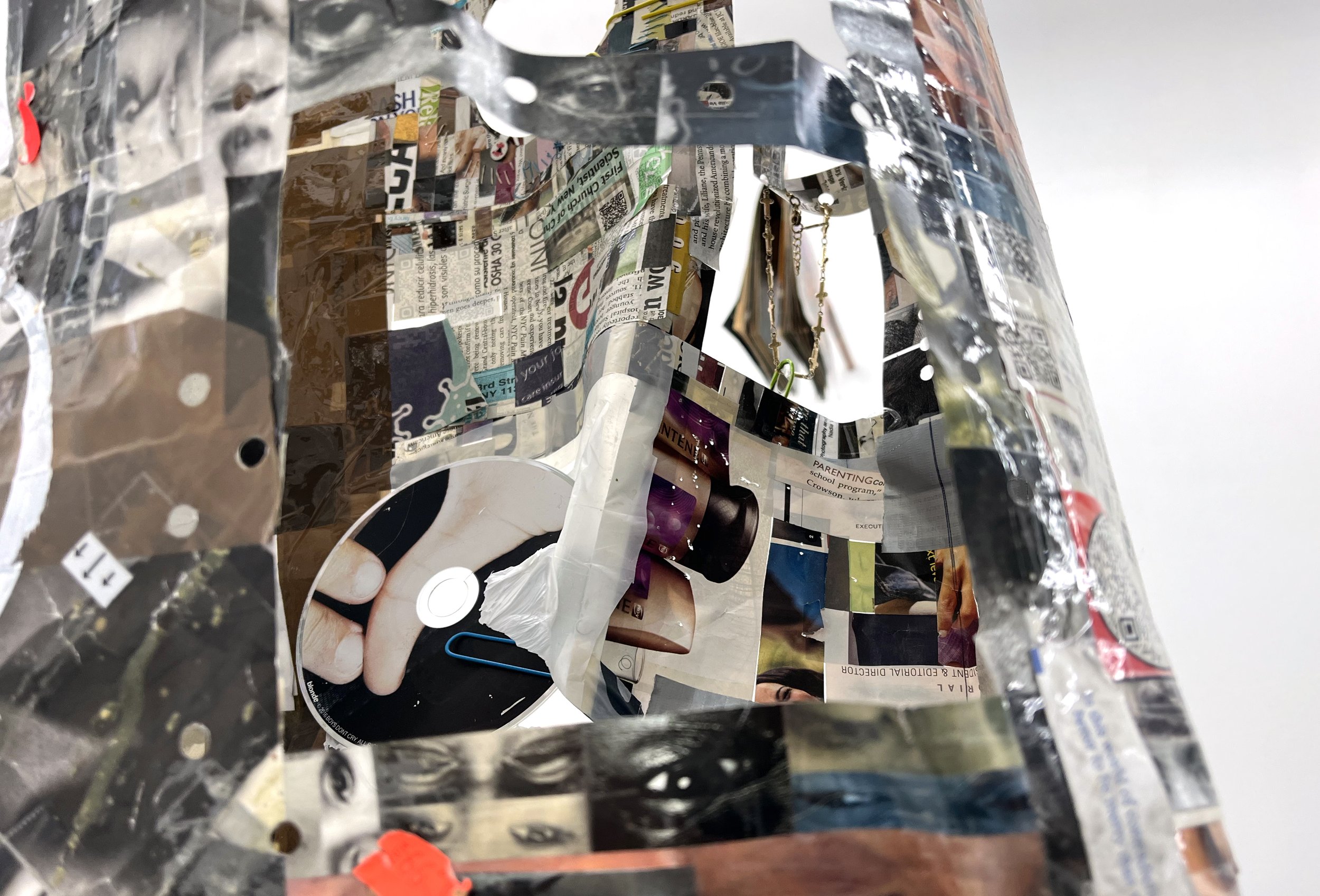  Elzie Williams III  If I Ruled The World (Time Traveler Bag) , 2023 (detail) magazines, found qr codes, clear tape, found objects, copper  26 x 18 x 6 inches (66 x 46 x 15 cm) EW9 