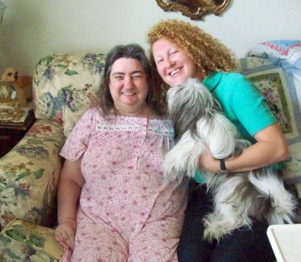 Michelle Belton owner of Companion Home Care with a happy client and her dog