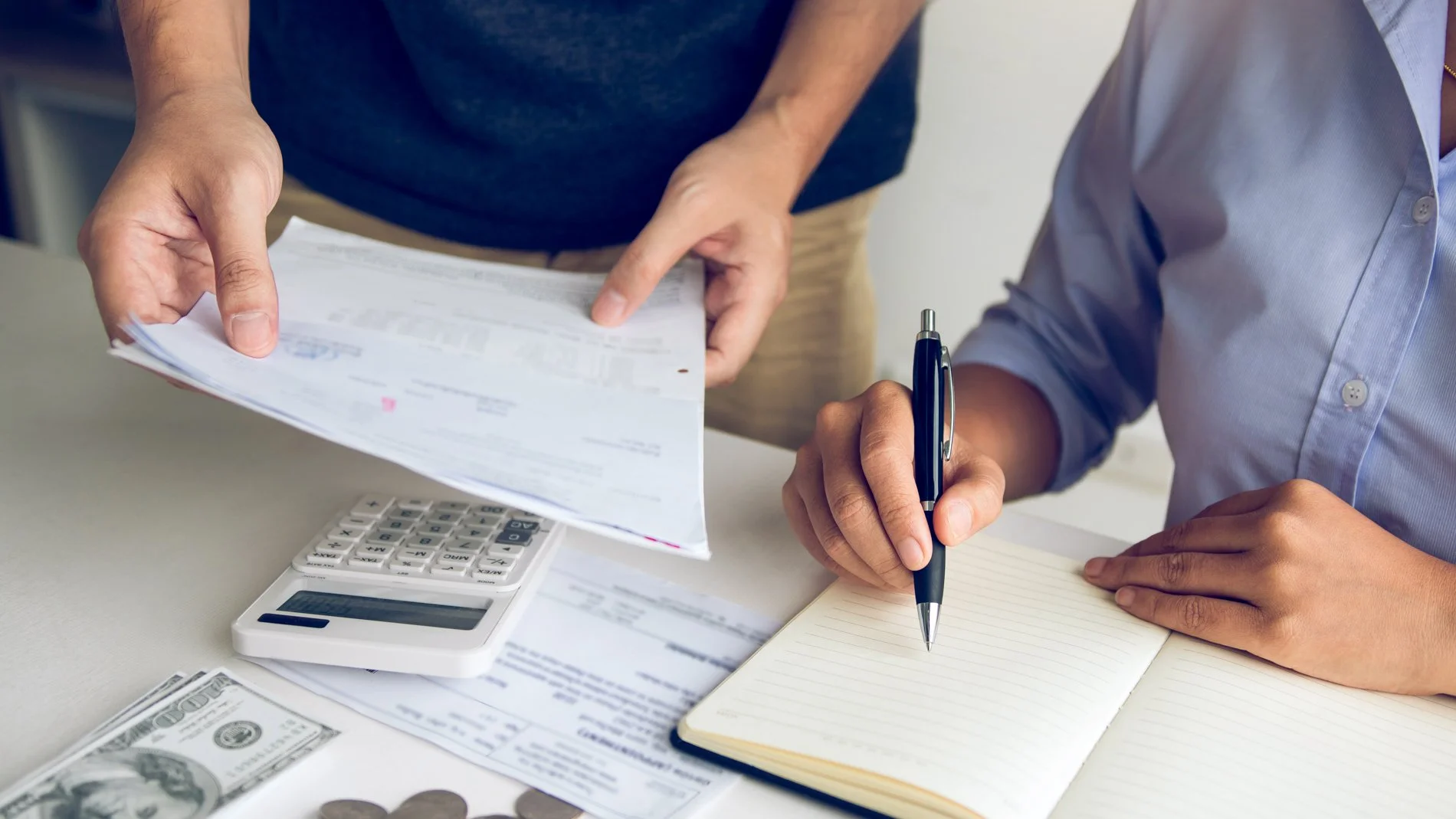 Small business owner reviewing financial documents with an accountant — year-end bookkeeping checklist for NWA small businesses