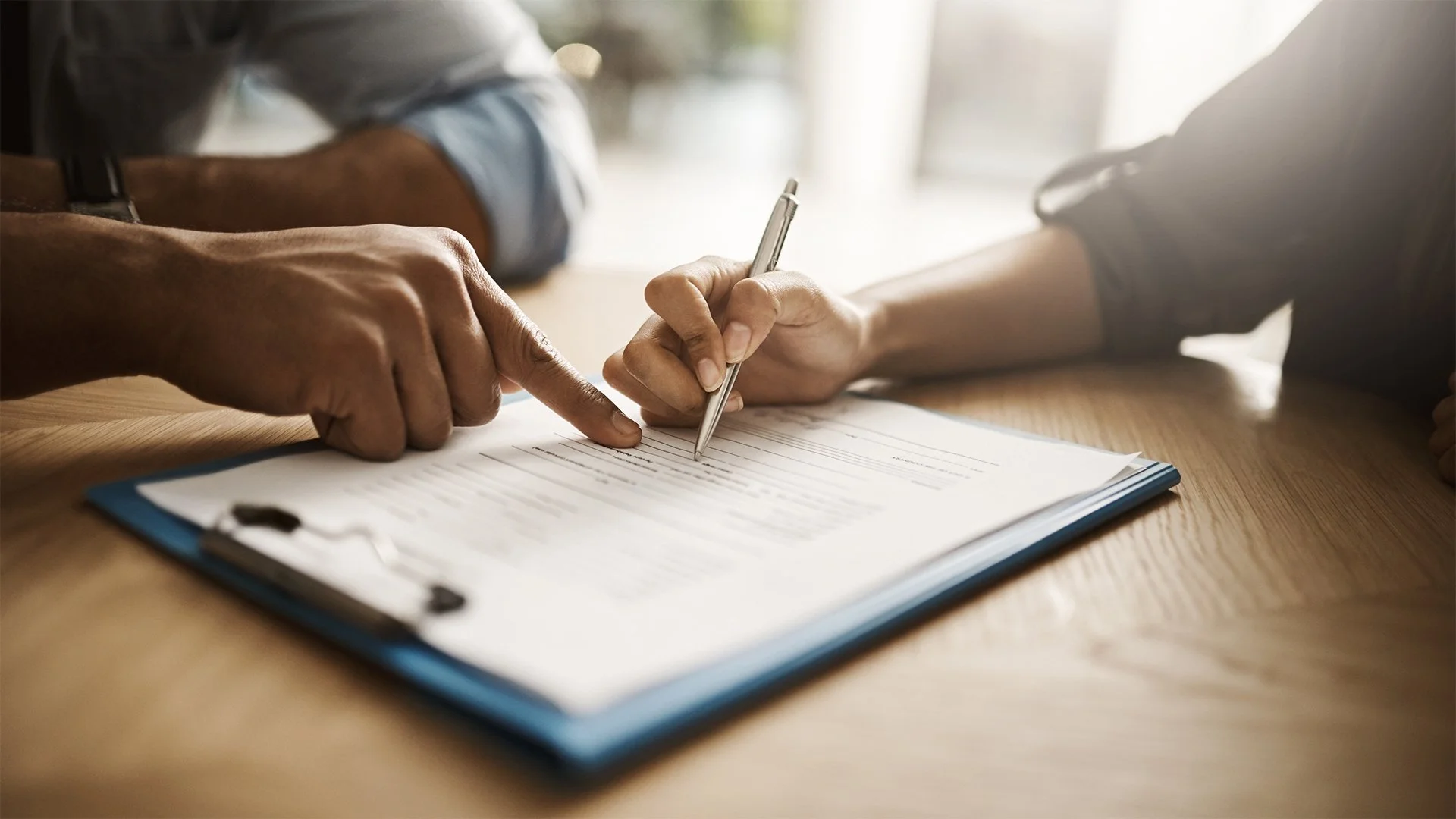 Small Business owner signing a contract, loan, or lease, taking on small business debt.