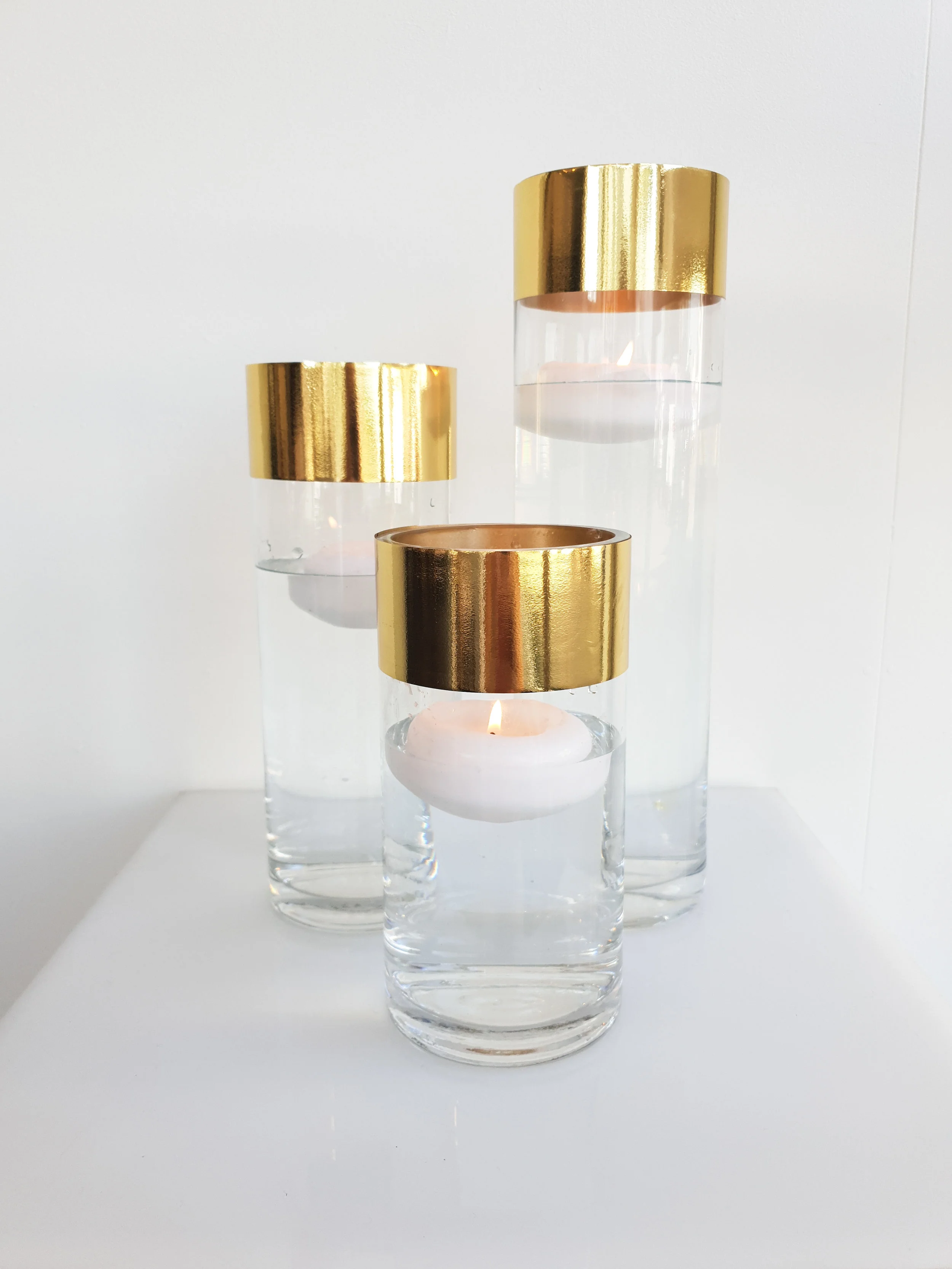 GOLD EDGE GLASS CYLINDER VASE WITH FLOATING CANDLE 20 CM H $8+GST 25 CM H $8+GST 30 CM H $10+GST 40 CM H $12+GST