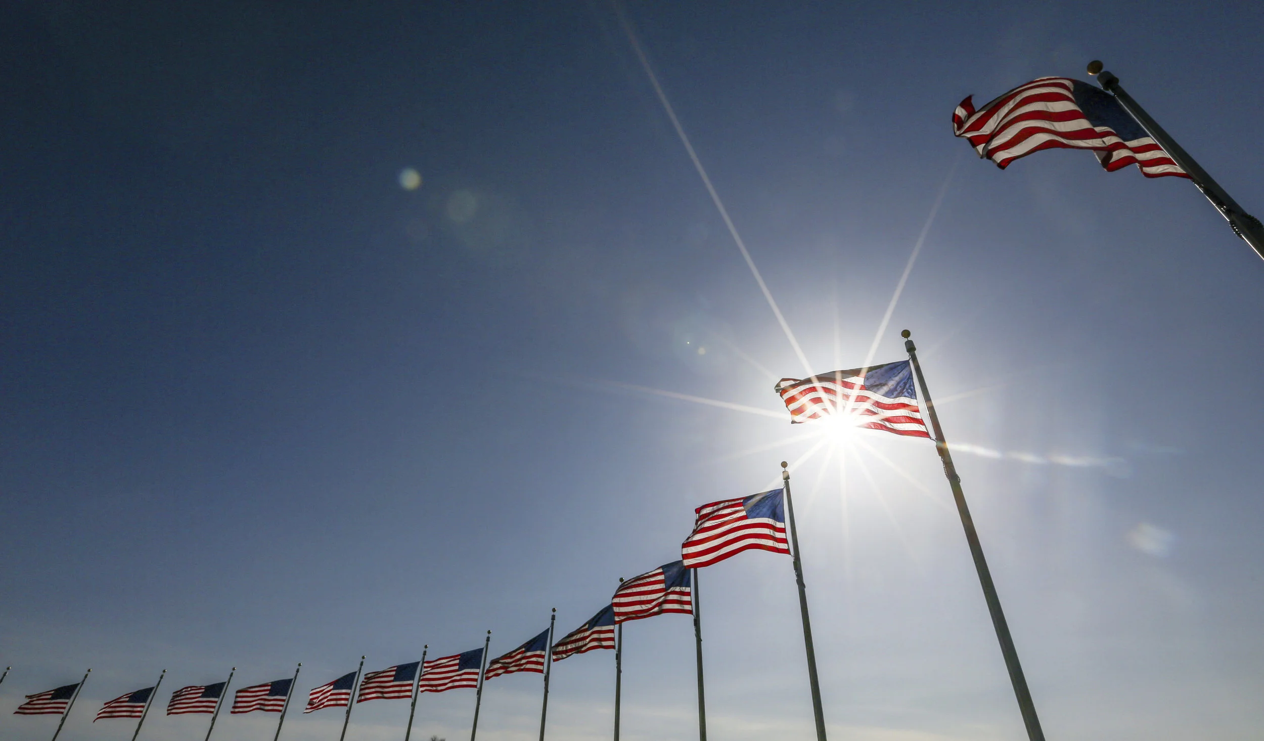 Flags waving against the blue sky iStock_000064689197_Double.jpg