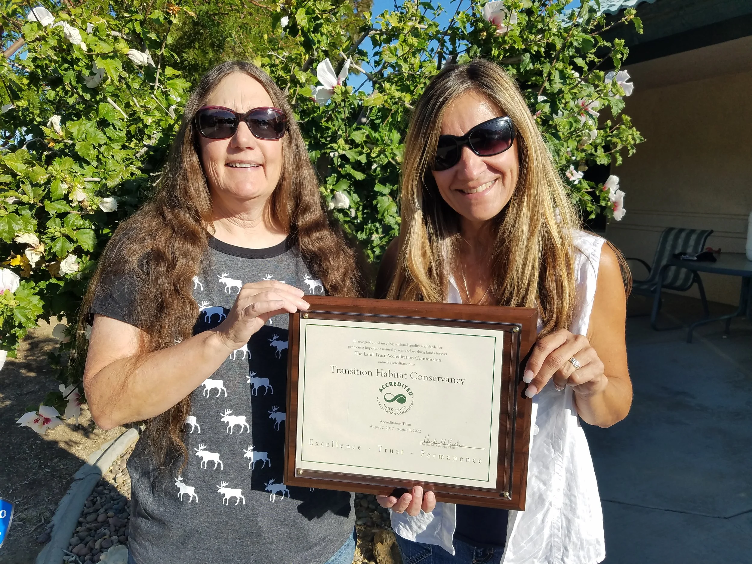 Founding Board Members, Jill Bays and Carol Hill, proudly display the accreditation certificate.