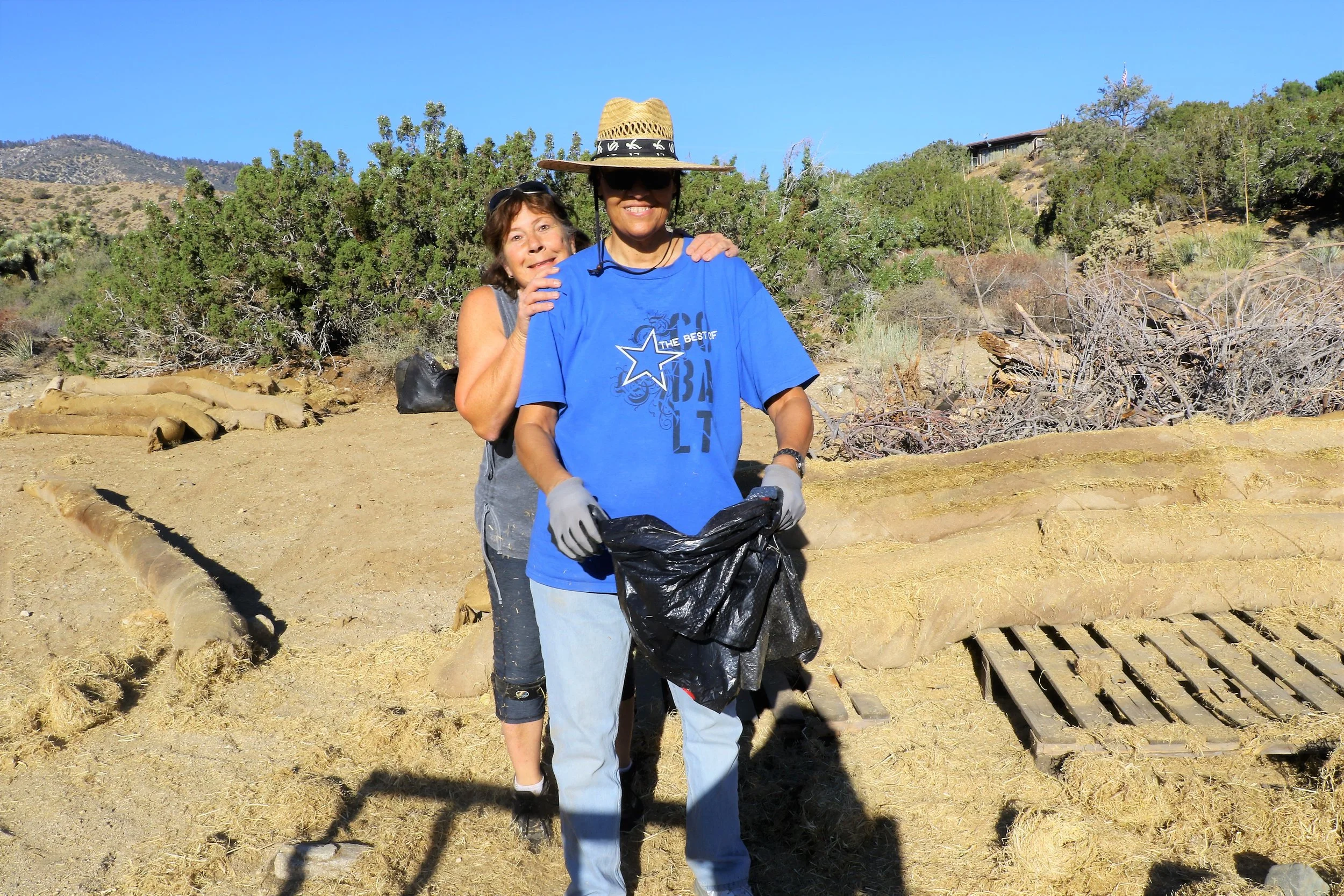 August 2018 Sue Harris and Angie Prudhomme taking a break from salvaging erosion wattles for use in Portal Ridge and Puma canyon project areas.