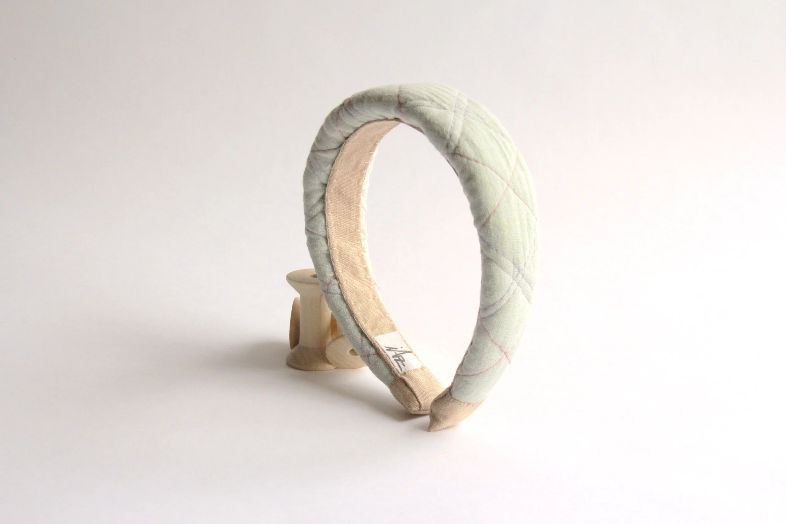 Hand-made coral Quilted headband with coral and lilac stitching