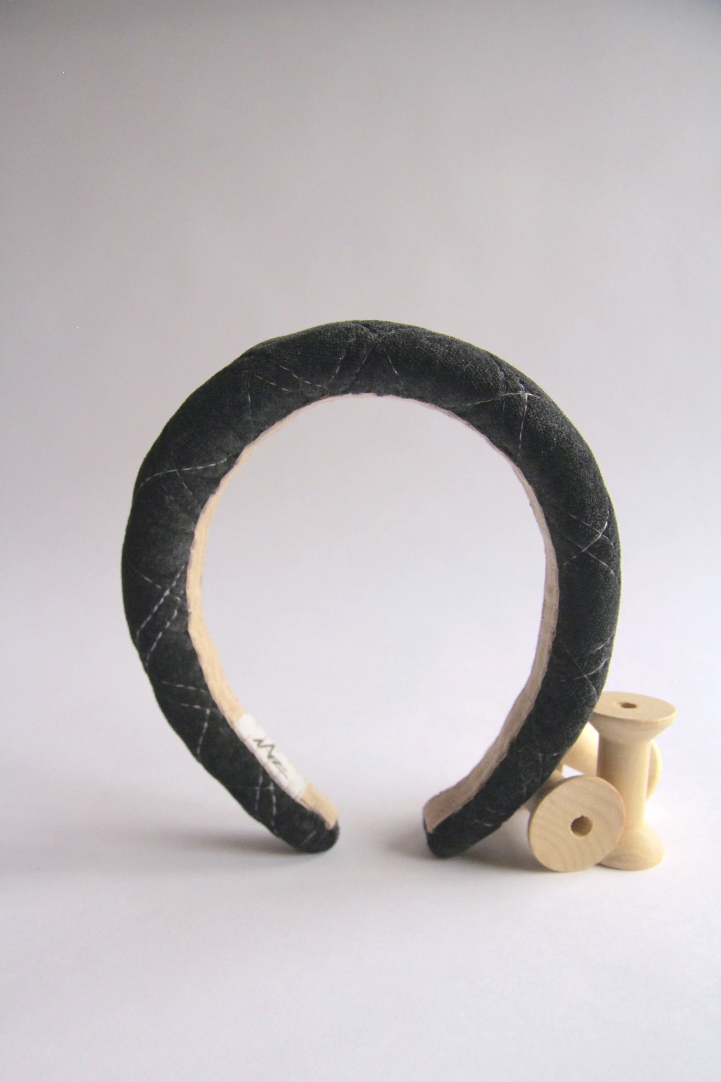 Hand-made dark grey Quilted velvet headband with sage and lilac stitching. Filled with organic cotton padding to add volume.