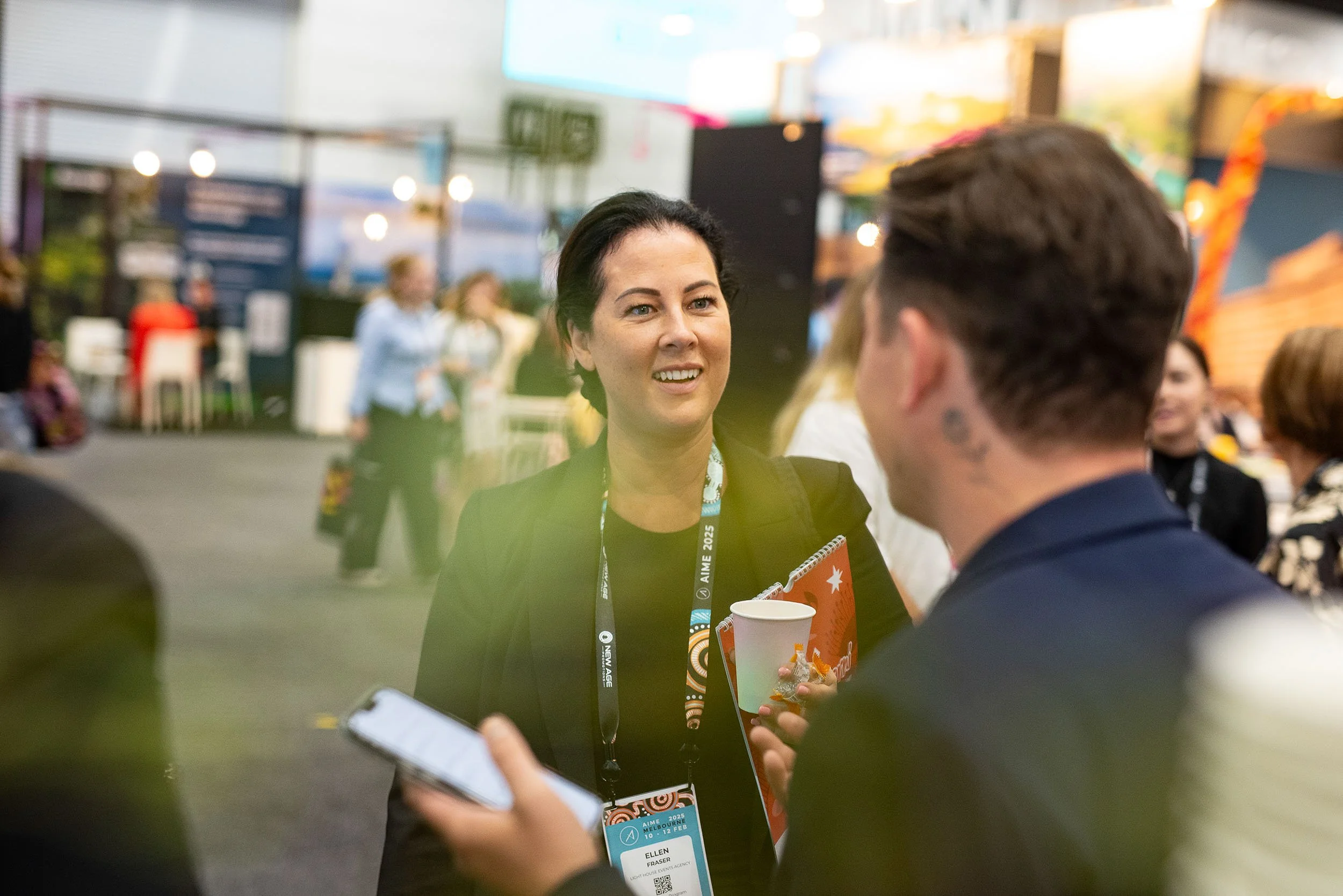Conference delegates networking on the exhibition floor at MCEC