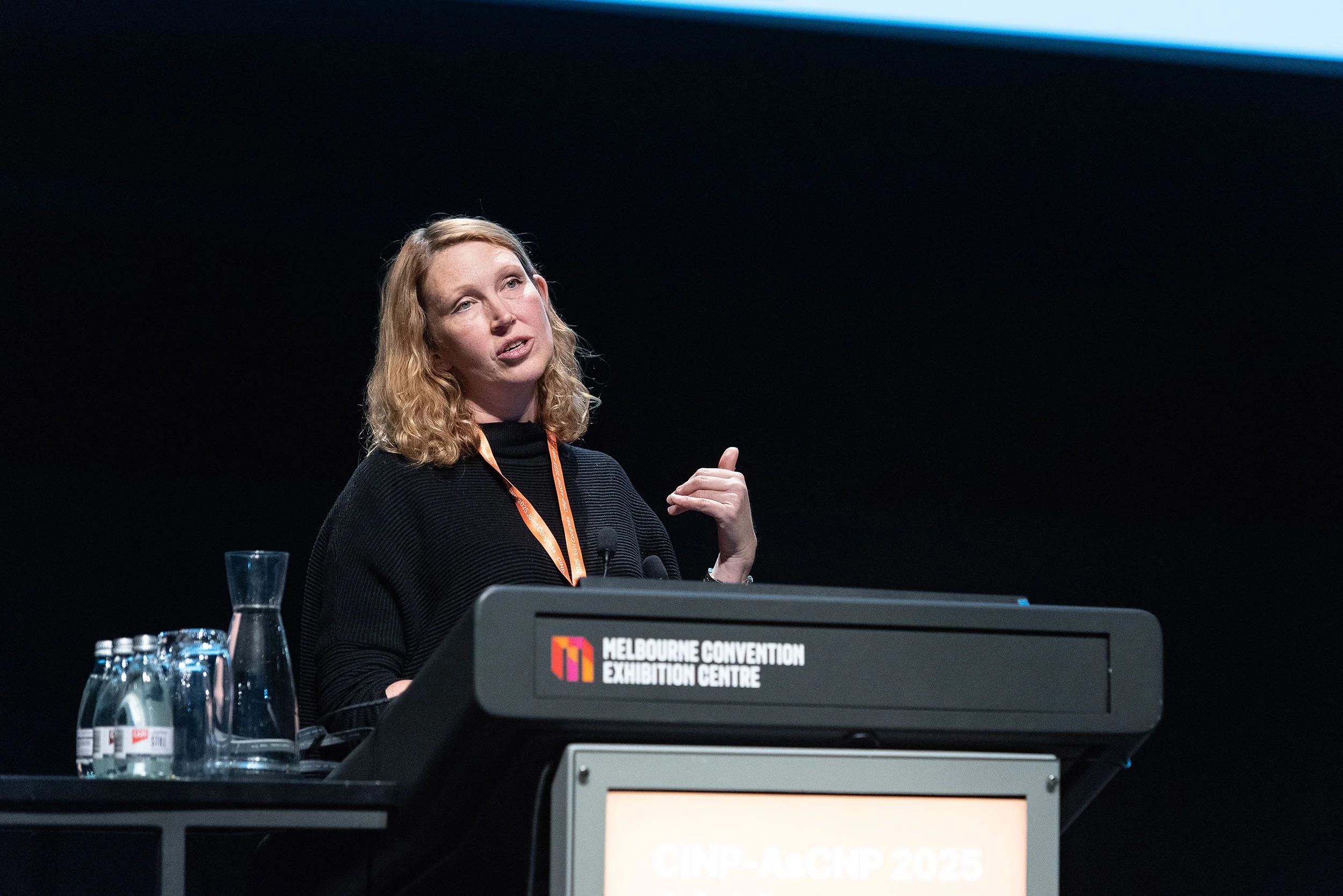 Conference speaker presenting from the lectern at MCEC