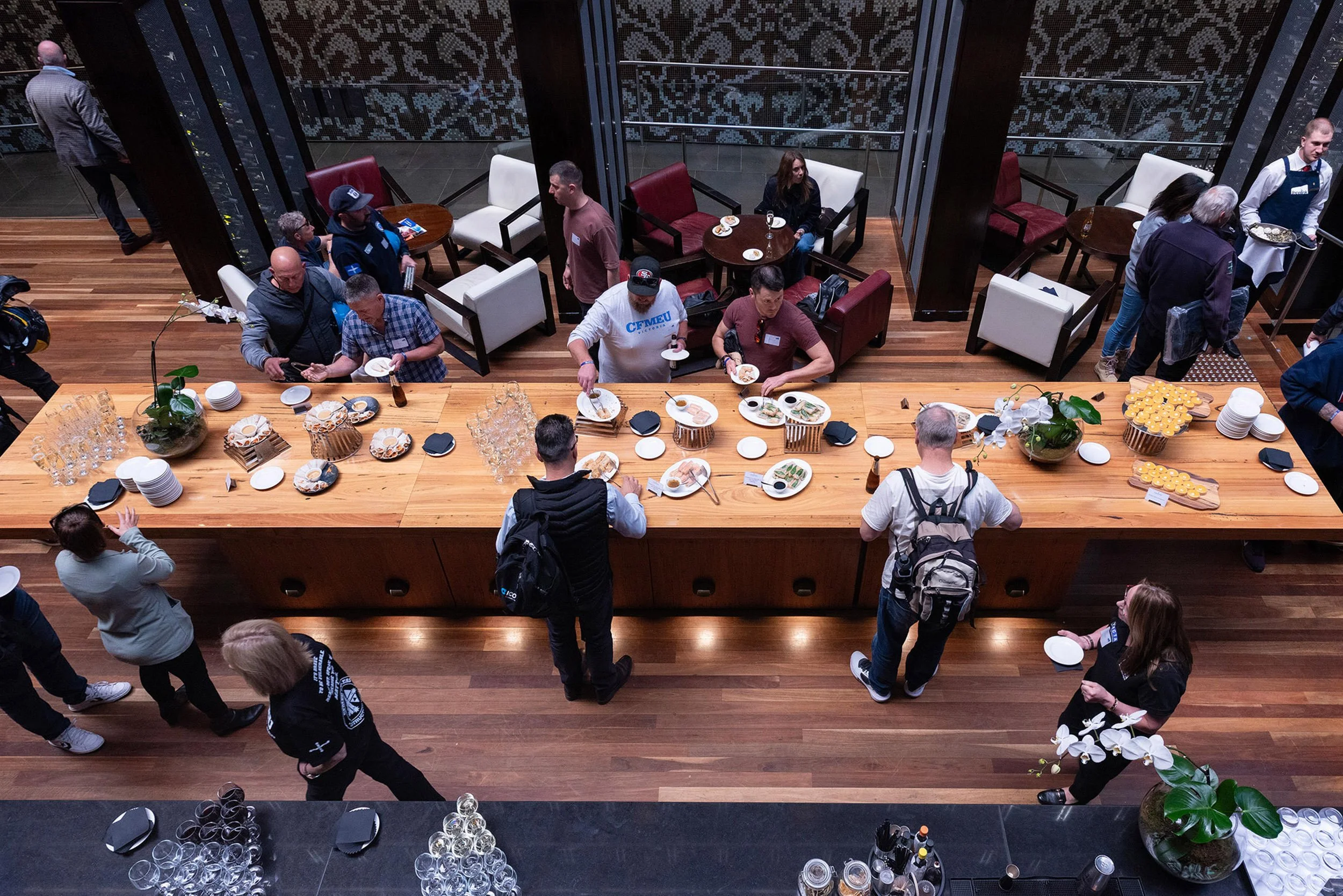 Overhead view of conference delegates around a long refreshments table in the atrium of InterContinental Melbourne The Rialto.