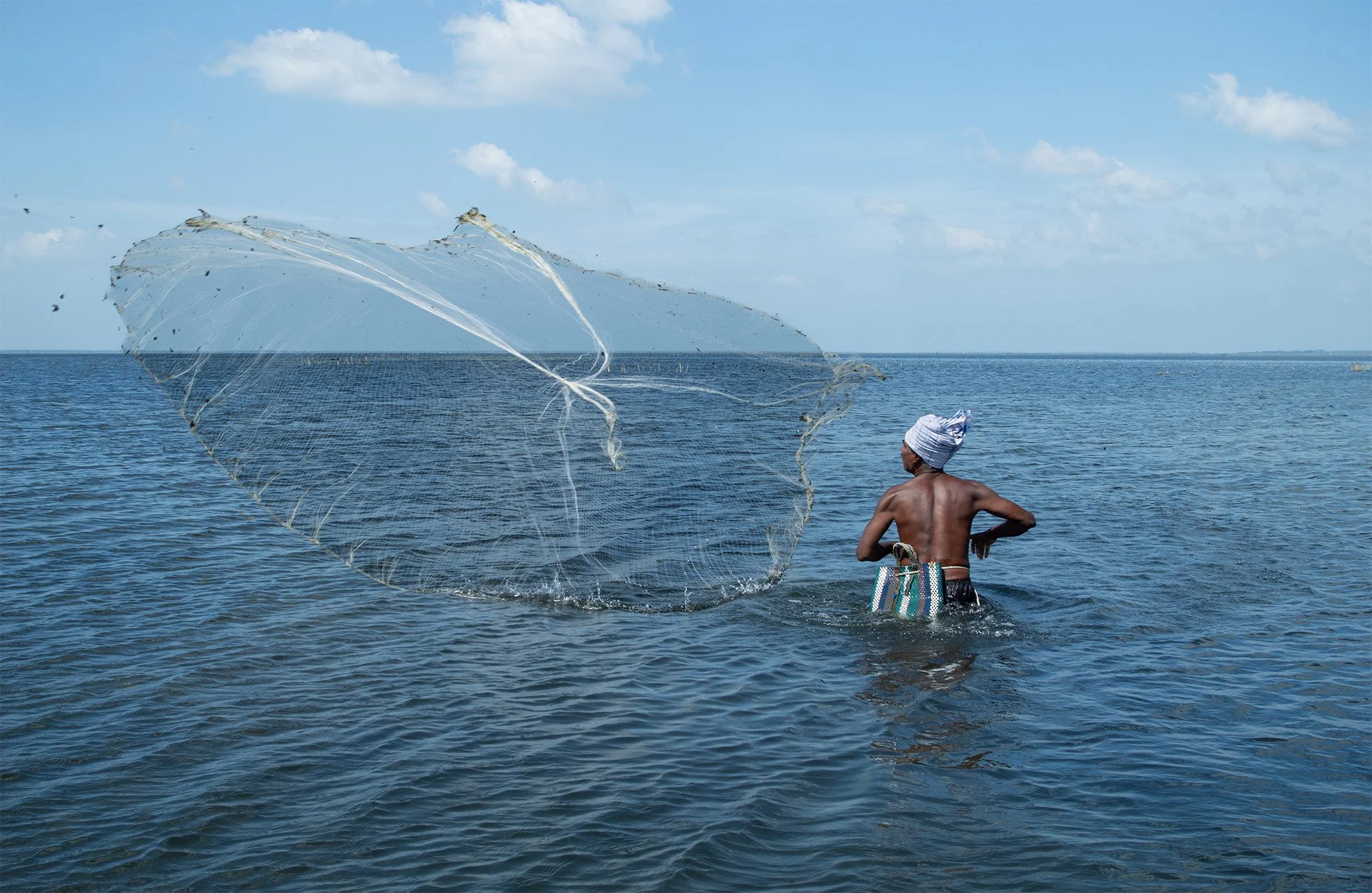 hamish-john-appleby-fisherman-casting-net-water-livelihoods.jpg