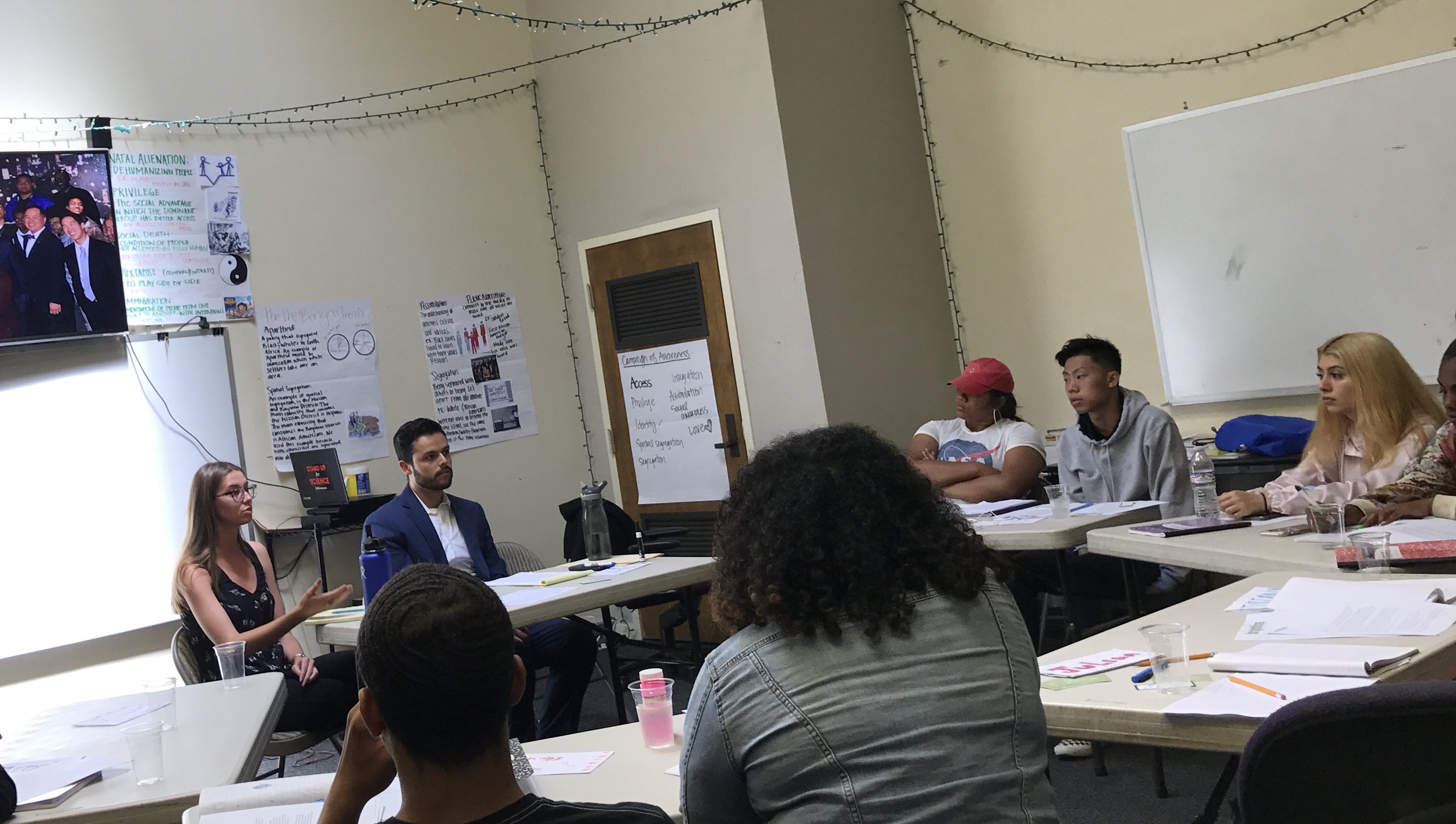Brightline policy fellow Gina Kotos and staff attorney Ivan Jimenez discuss Green Zones with the Resilient Youth Leadership Academy in Bayview-Hunters Point, July 2018. 