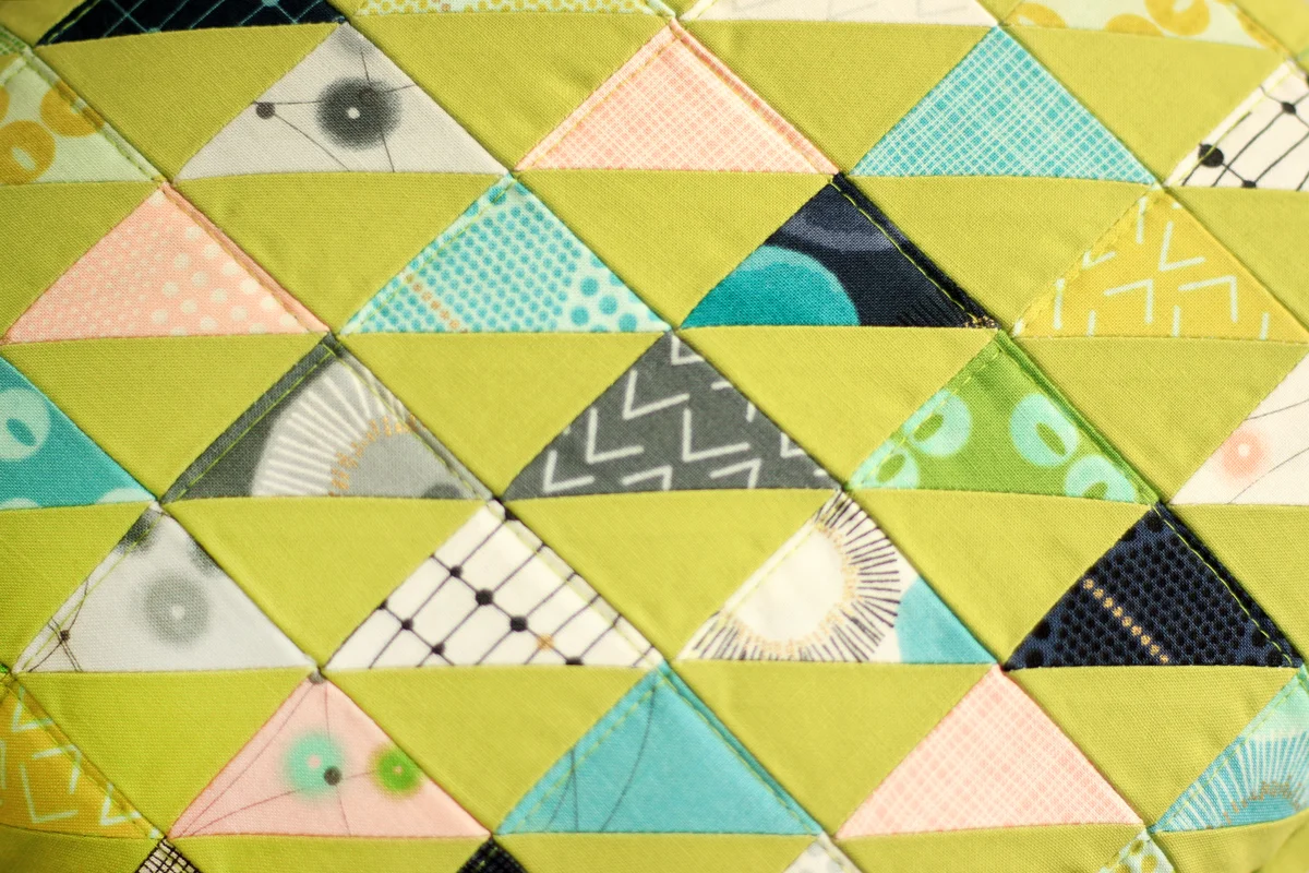 Chartreuse paired with the cool hues and elegant gold accents of the day in the Paris fabric line creates a chic, modern look to this pillow.