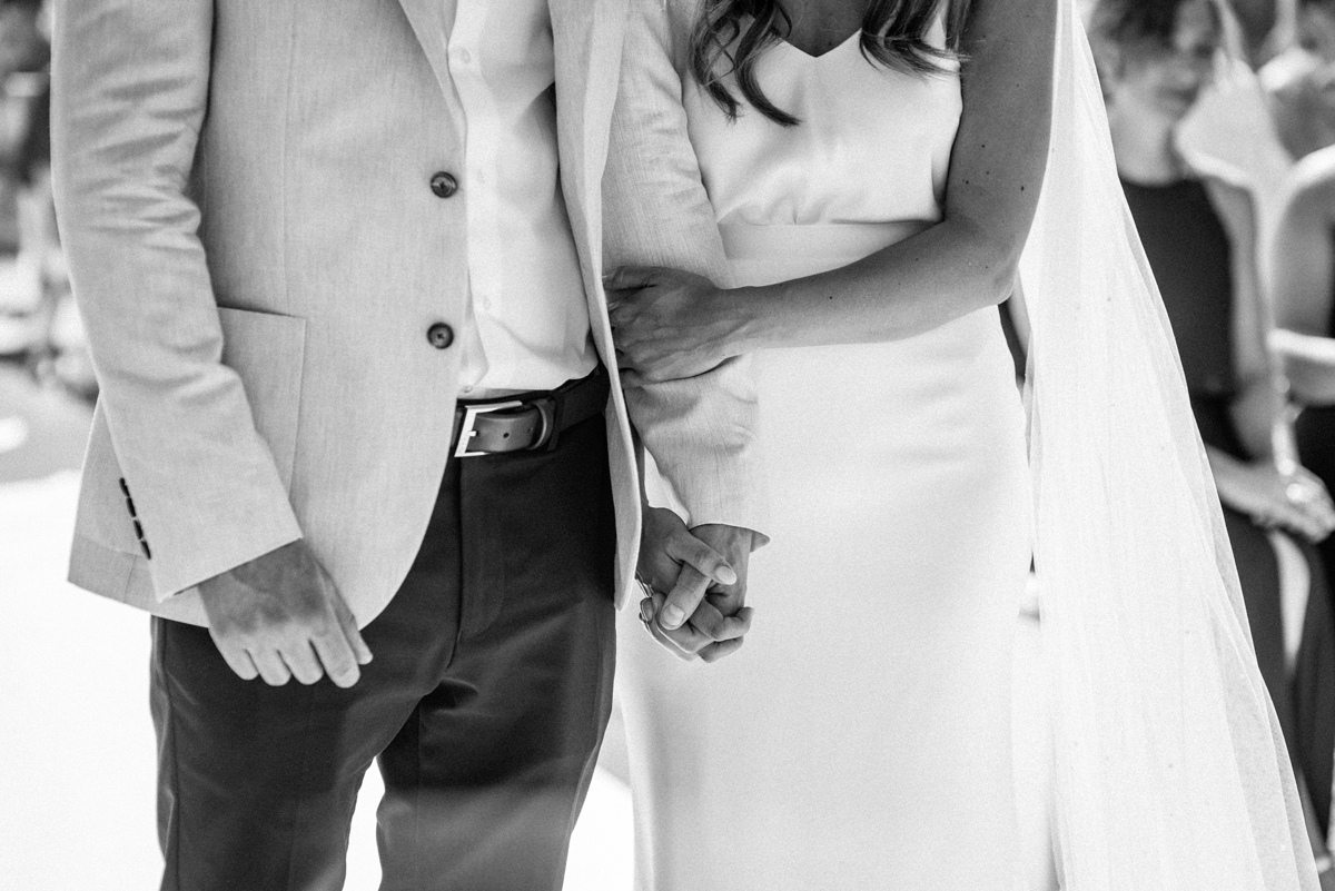 Wedding couple holding hands during ceremony at La Escollera Ibiza