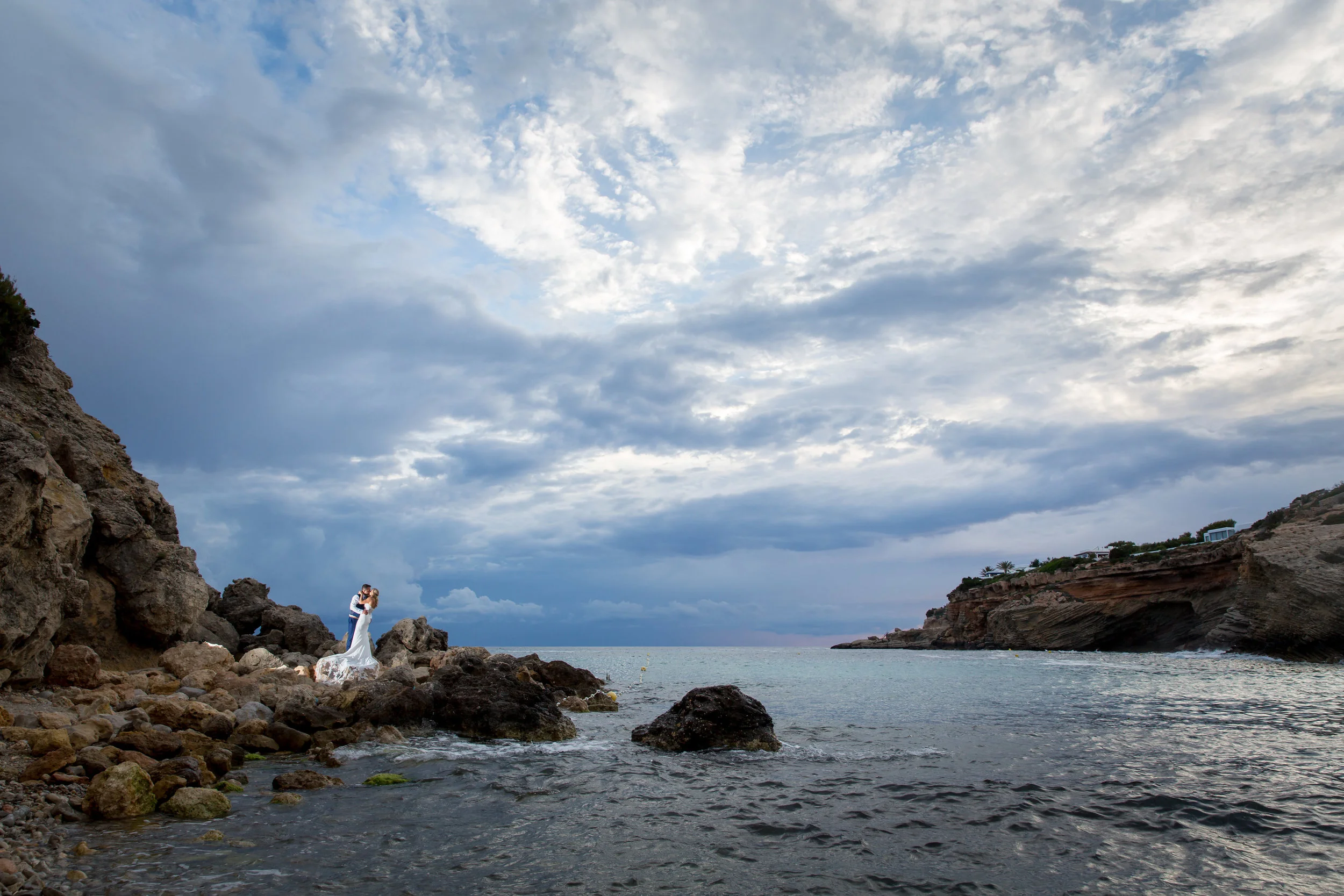 Bride and Groom kiss on the beach of Es Codolar, Ibiza. Photo by Matt Morgan.
