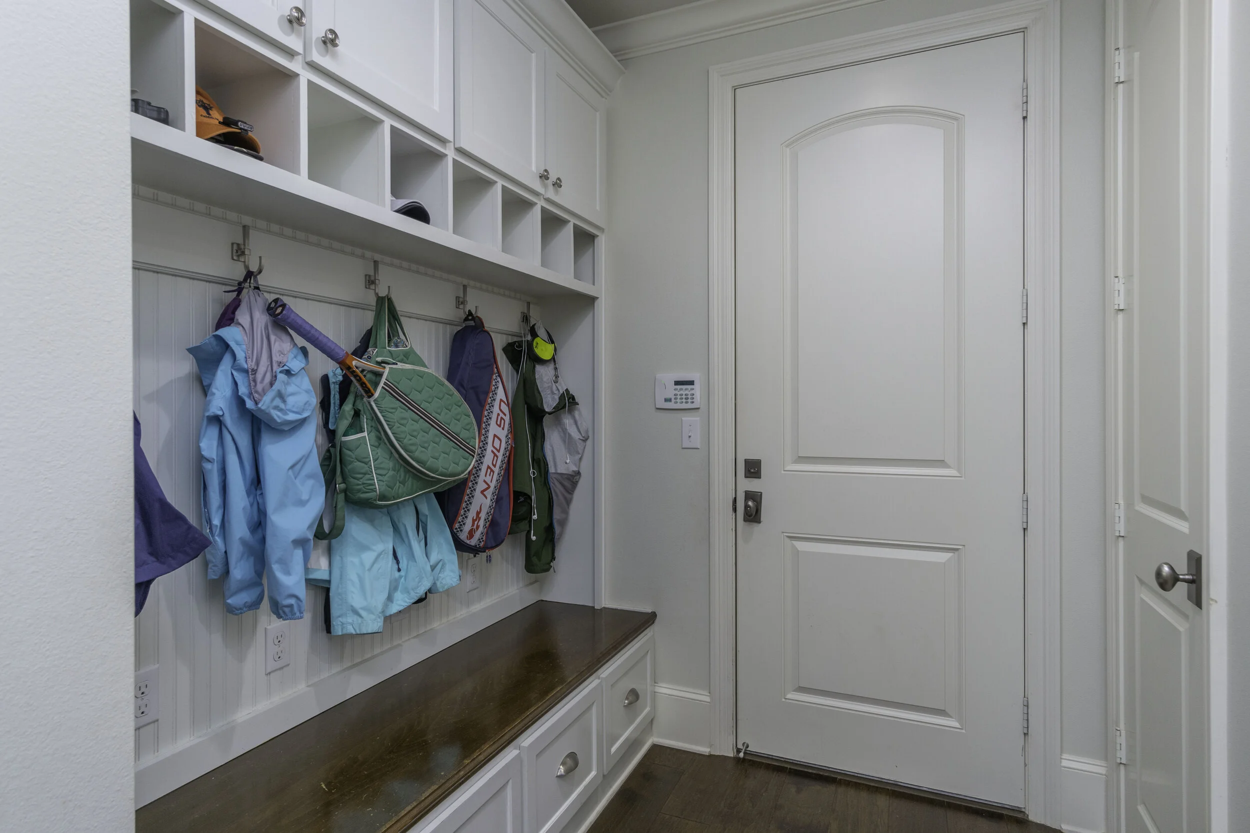 The built-in hall tree is a great space to store jackets, purses, backpacks, and briefcases as soon as you enter the house from the garage.