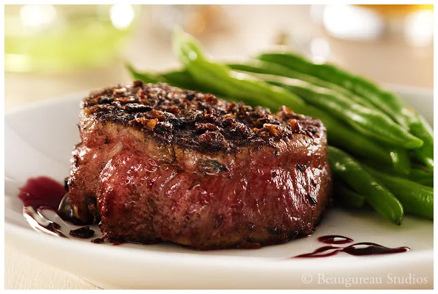 A savory mushroom crust surrounds tender beef filets in this recipe, aside from the red wine reduction.