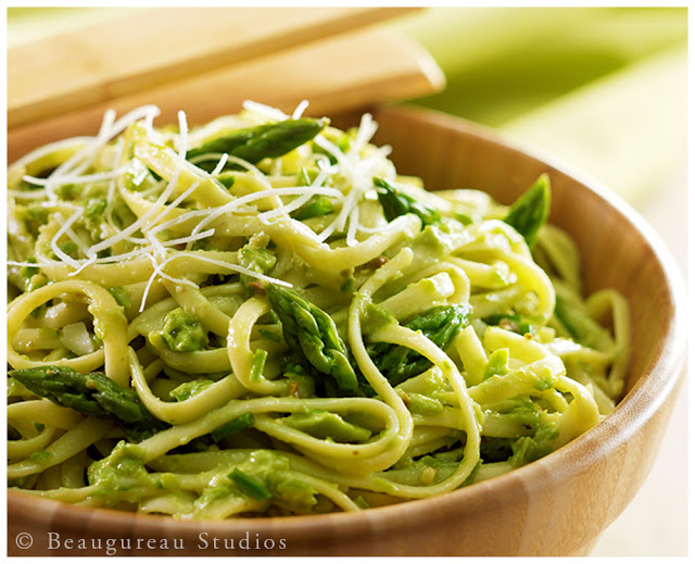 Pasta and a homemade pesto, topped with shredded parmesan cheese.