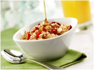 Granola clusters mixed with dried berries, shaved almonds and topped with honey.