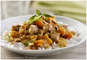 A chicken curry made with blood orange slices, and chopped pineapple. Topped with almonds and greens.