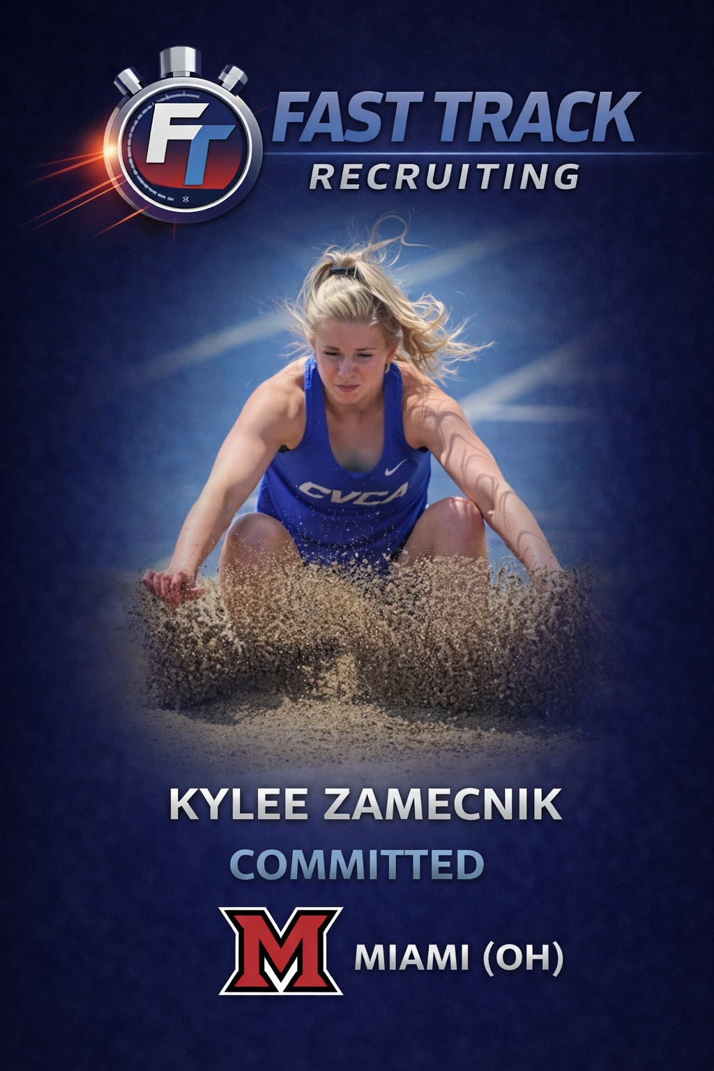 Female athlete in a blue uniform landing in a sandpit during a track and field long jump event.