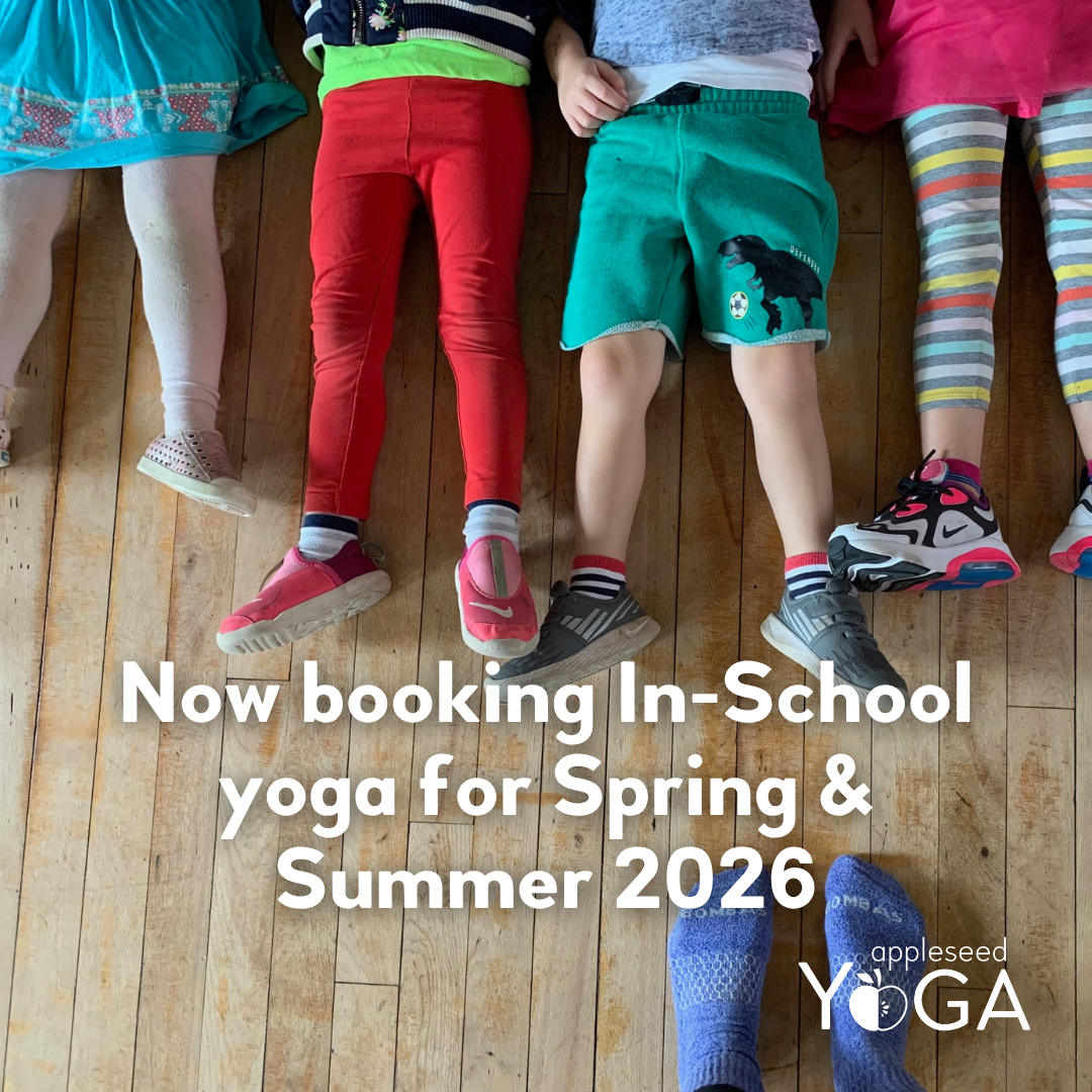 Legs and feet stretched out on a wood floor with the words 'Now booking In-School yoga for Spring and Summer 2026' overlaid.