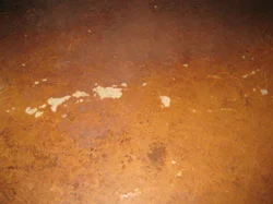 Without periodic recoating, this is an example of the damage that can happen to a stained concrete floor as the sealer is worn through or delaminates.