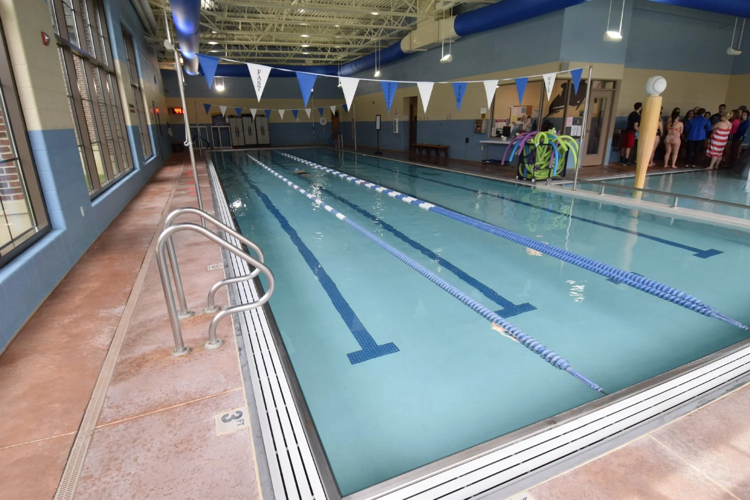 Discolored Commercial, Indoor Concrete Pool Deck Before Resurfacing With Spray-Texture Decorative Cement Overlay