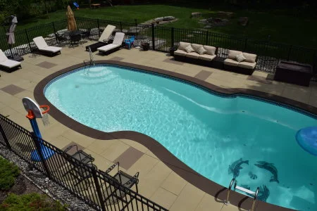 Integrally-colored, "spray-texture" concrete overlays create a perfect decorative finish on plain gray outdoor pool decks. Spray texture overlays look great, have ideal slip-resistance and are easy to clean and maintain.