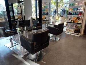 Decorative concrete flooring with a high performance, chemical-resistant clear sealer is a common choice for hair salons. The flooring in this particular salon is a 3/8" self-leveling cement overlay colored with brown concrete dye.